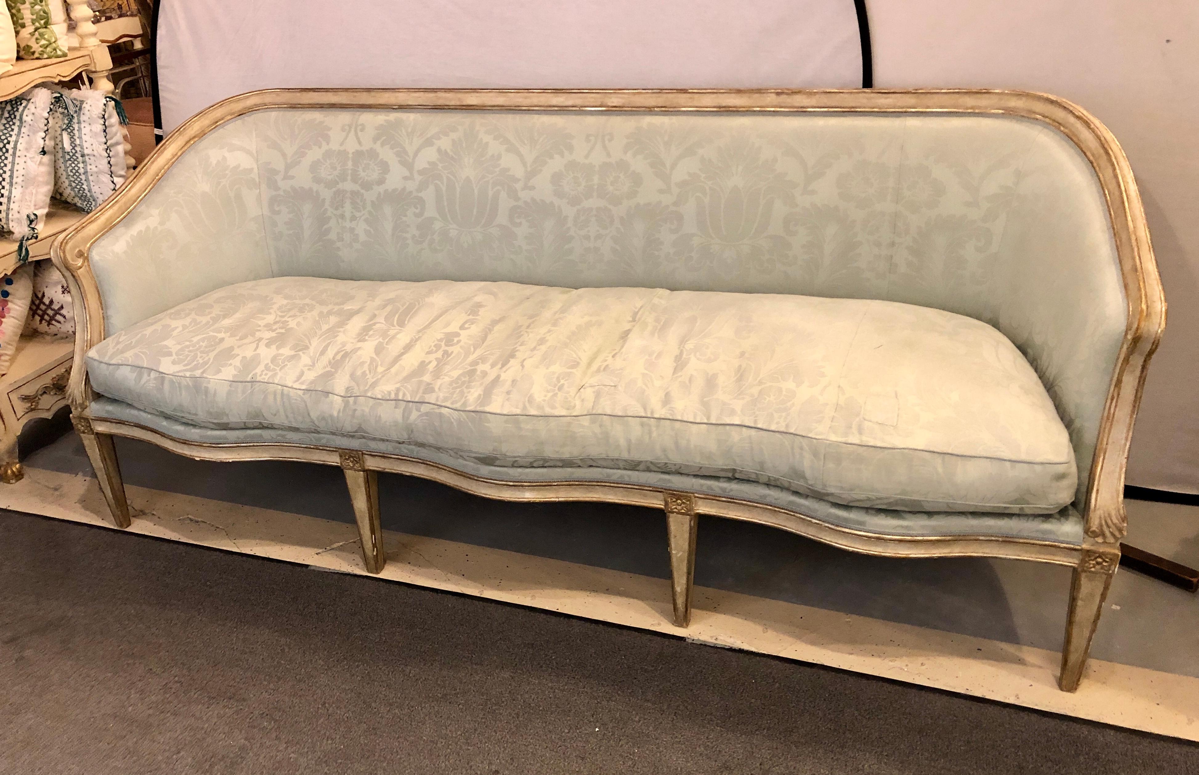 A late 19th century Swedish gilt and parcel paint decorated sofa. The frame in a nice damask upholstery that has a few blemishes and tears. The frame in fine sturdy strong condition. Fresh out of a Park Avenue apartment.