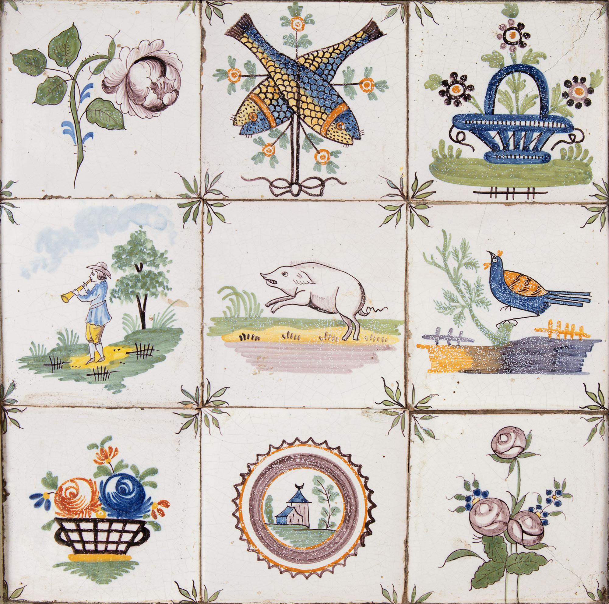 A late 19th century painted table with charming tiled top, the tiles showing scenes of country life such as animals and bouquets, supported on tapering legs terminating in brass sabots.