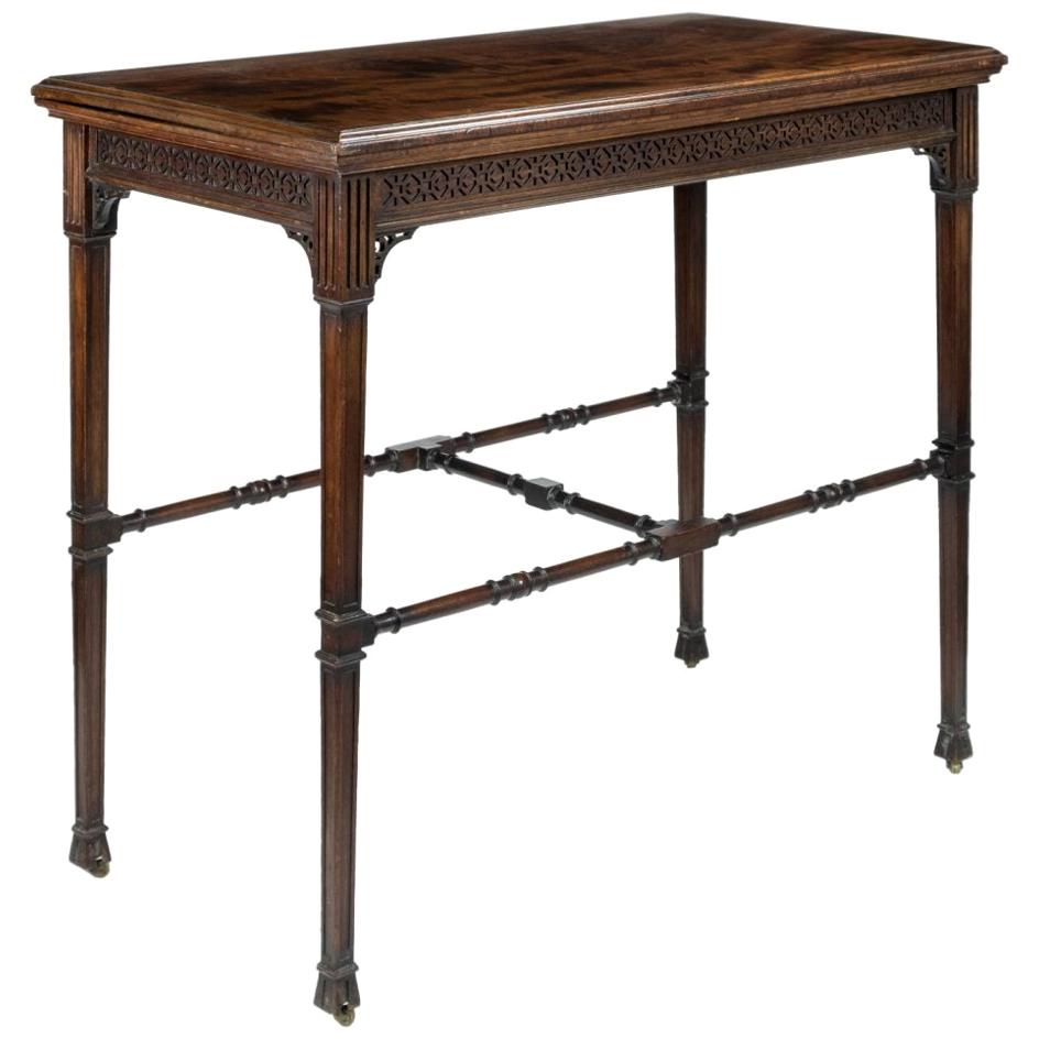 A late 19th-early 20th century Gillow & Co. mahogany turnover top card table, with blind fretwork frieze, raised on tapered legs of square section united by ring turned stretchers, signed “Gillow & Co.
Gillows of Lancaster and London, also known as