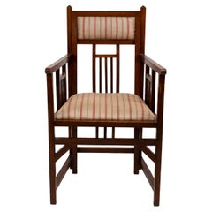 Bombay Art Furniture An Anglo-Japanese Walnut armchair with a double back leg.