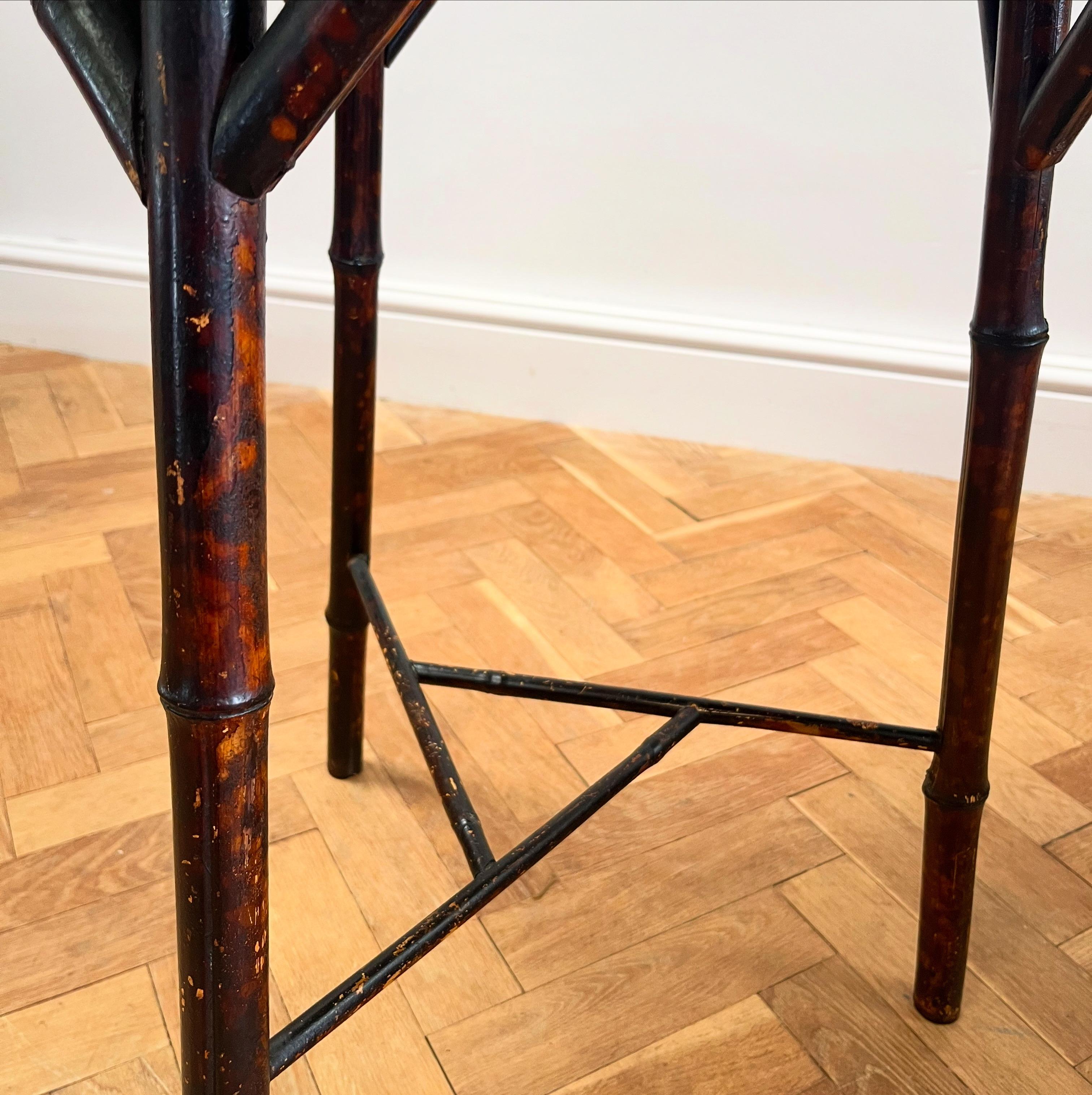 A sculptural table with caned octagonal top above three bamboo legs connected by stretcher forming a central triangle.

English, Late Nineteenth Century 

H 70 x W 54 cms 