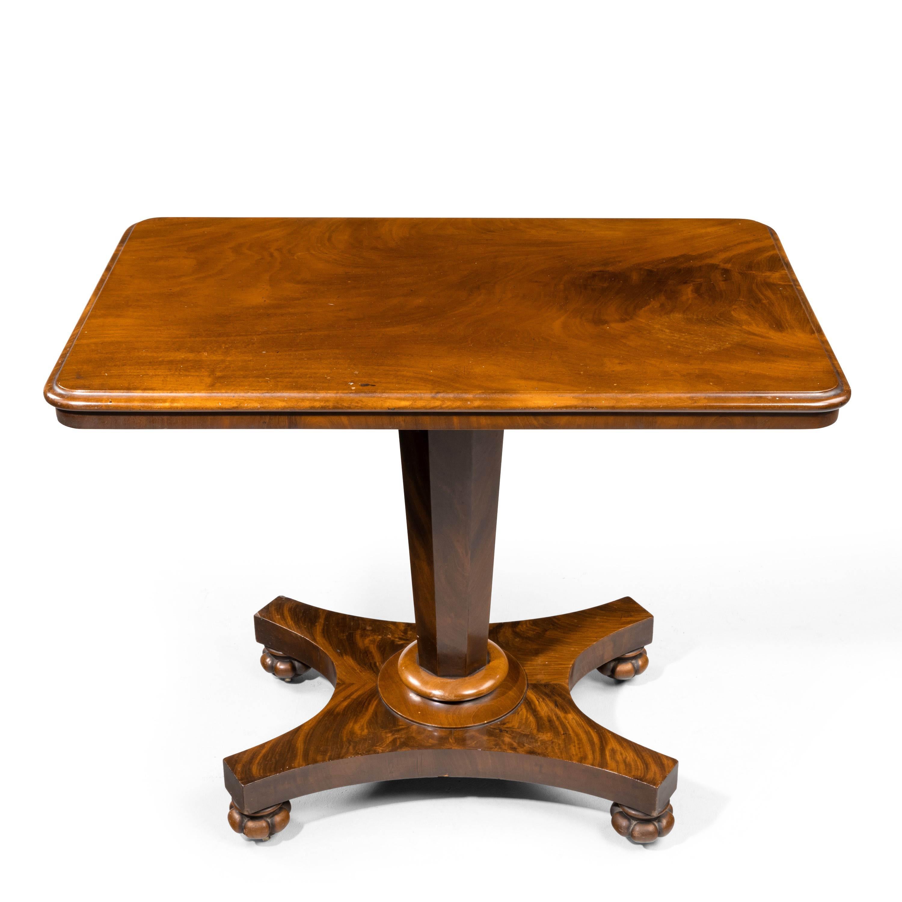 A late Regency period centre standing occasional table. On very well figured timbers with a shaped octagonal support over a serpentine platform base. Retaining the original shaped and carved feet.