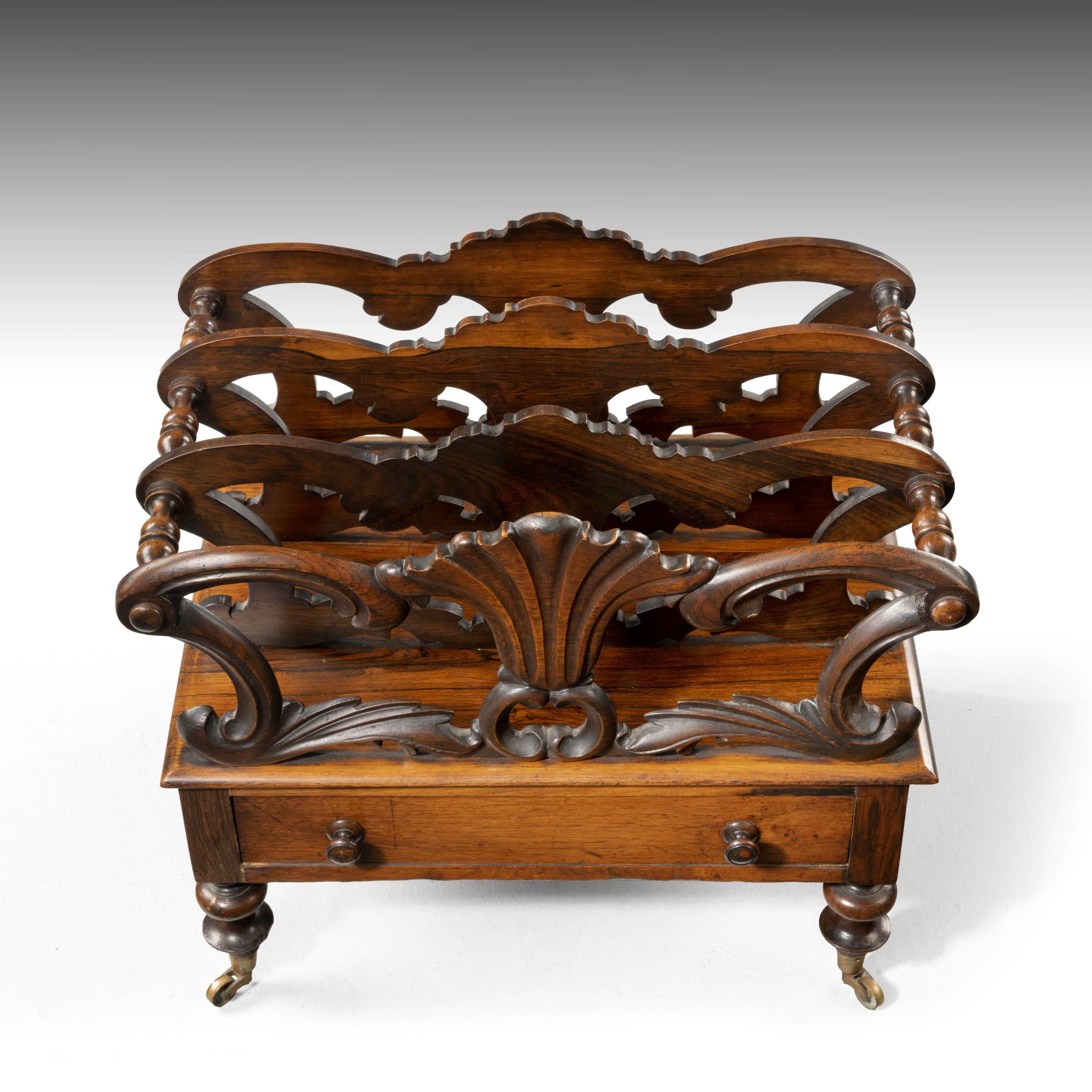 A late Regency period mahogany Canterbury after a design by Ludon? The single drawer with a turn written on. Turned supports retaining the original shoes and castors.
  