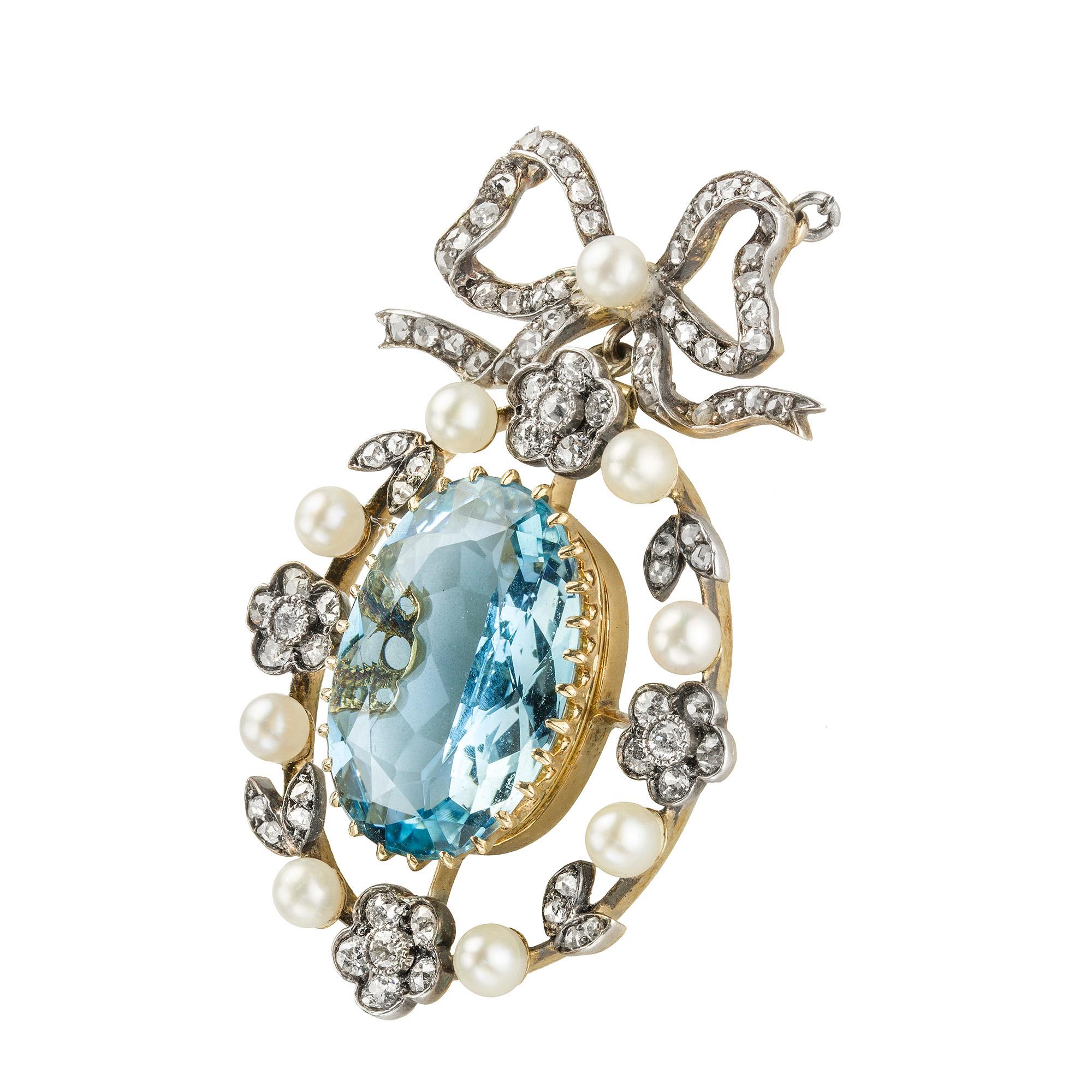 A late Victorian aquamarine, diamond and pearl pendant, the oval aquamarine estimated to weigh 7.40 carats, claw-set to a gold collet, surrounded by a pearl and diamond floral frame with diamond-set ribbon top, accompanied by gold brooch fitting in