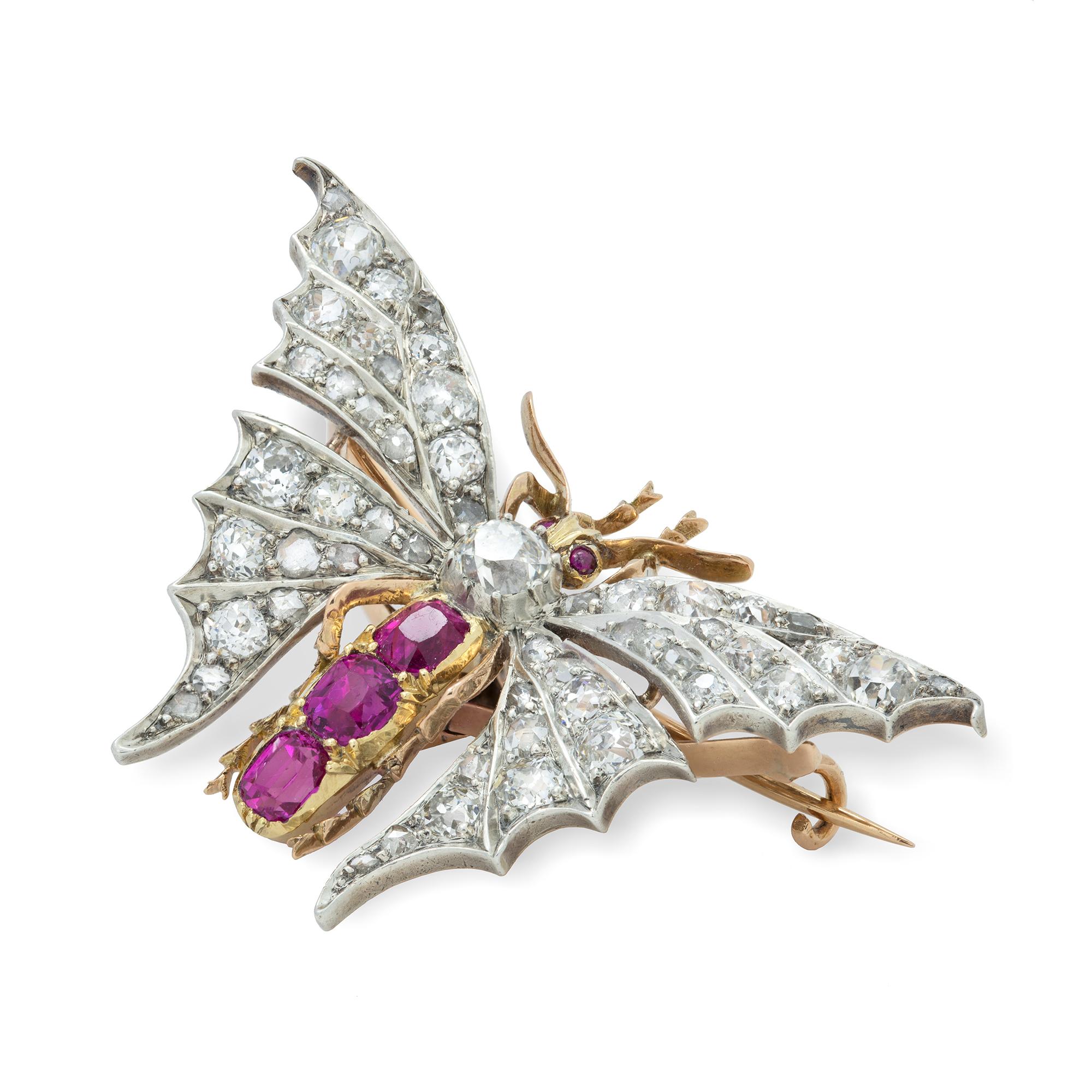 A late Victorian Burmese ruby and diamond butterfly brooch, the thorax and wings set with old European and rose-cut diamonds weighing approximately 4 carats in total, the abdomen and eyes set with faceted rubies, weighing approximately 1.3 carats in