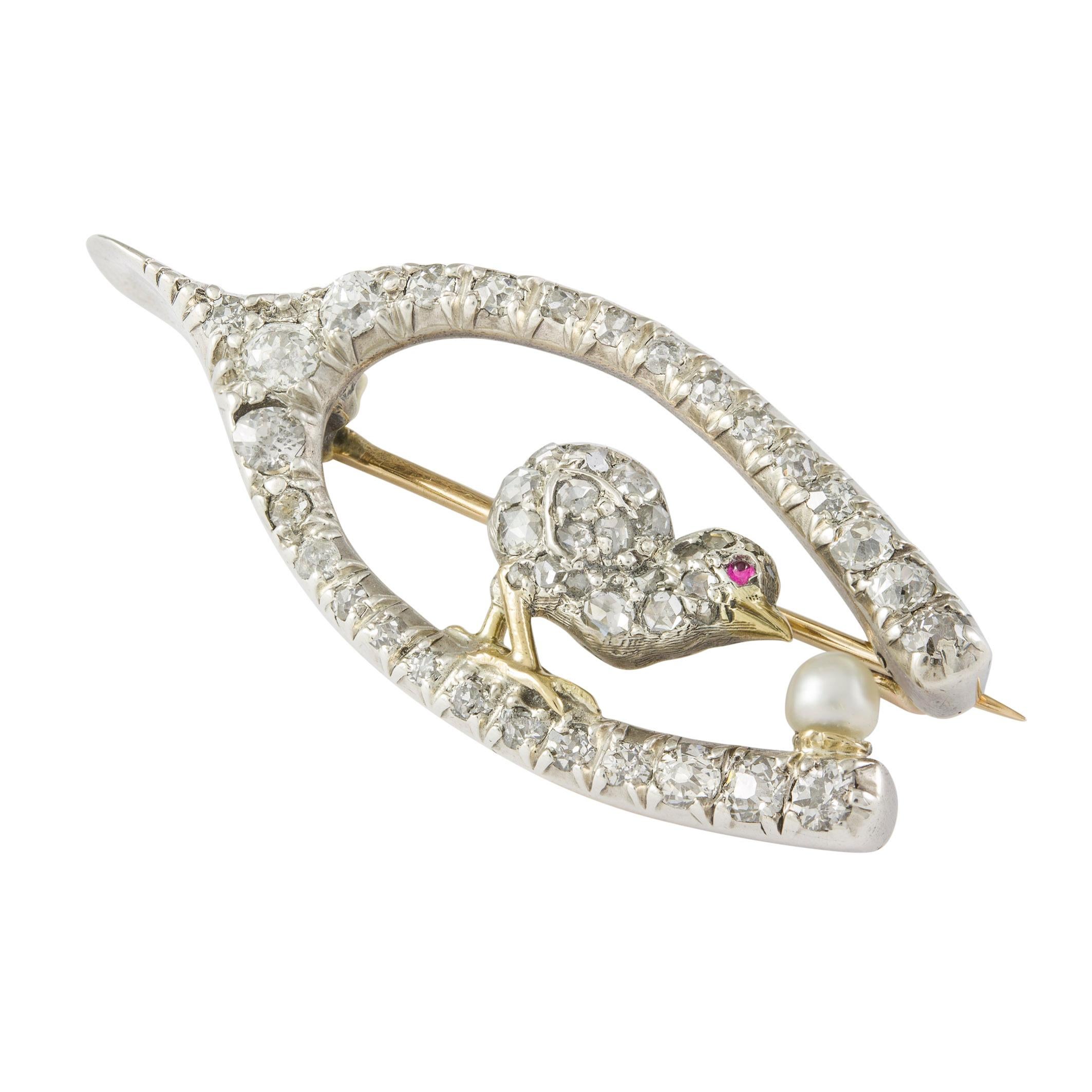 A late Victorian wishbone and chick brooch, the chick set with rose-cut diamonds and cabochon ruby-set eye, facing an natural pearl in the form of egg, all within an old-cut diamond-set wishbone, the diamonds estimated to weigh 1 carat, all set in