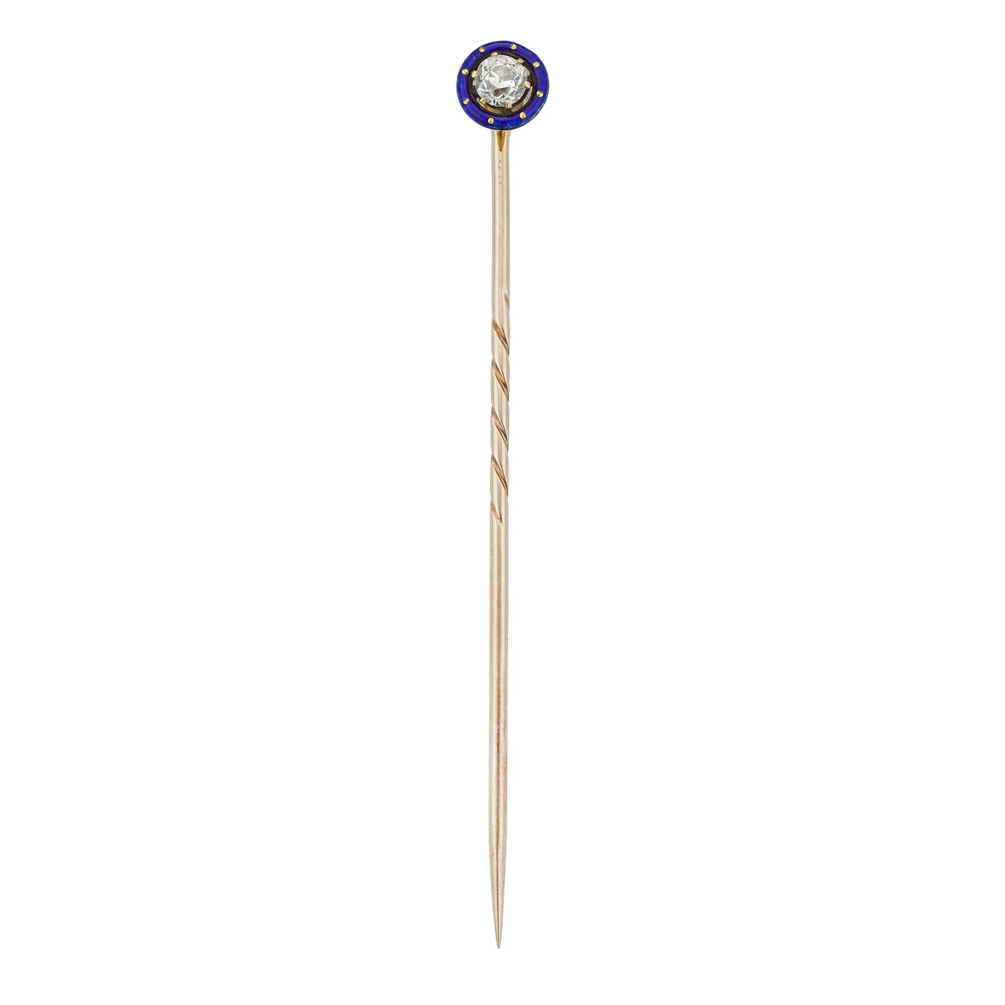 A late Victorian diamond and blue enamel stick pin, the old-cut diamond estimated to weigh 1/3 of a carat, six-claw set surrounded by blue enamelled frame with daylight in-between, mounted in yellow gold, with rose gold pin fitting, circa 1890,