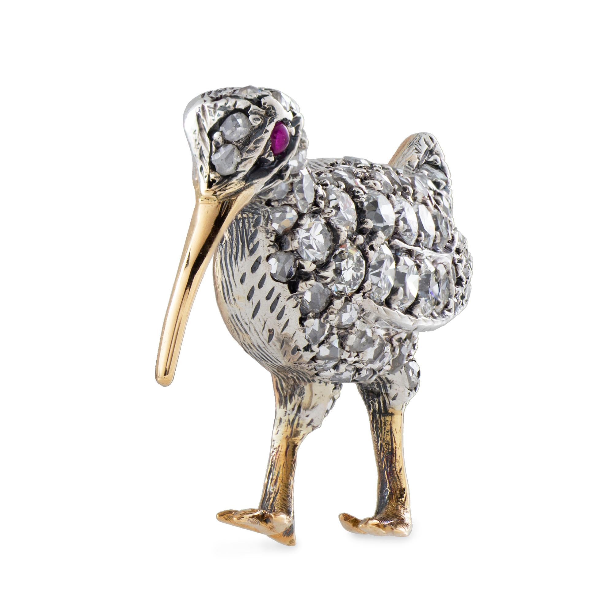 A late Victorian diamond bird brooch, finely modelled in the form of a curlew, the head and plumage encrusted with old brilliant-cut and rose-cut diamonds, grain to a silver mount with 18ct yellow gold legs, bill and mount, with a cabochon ruby eye,