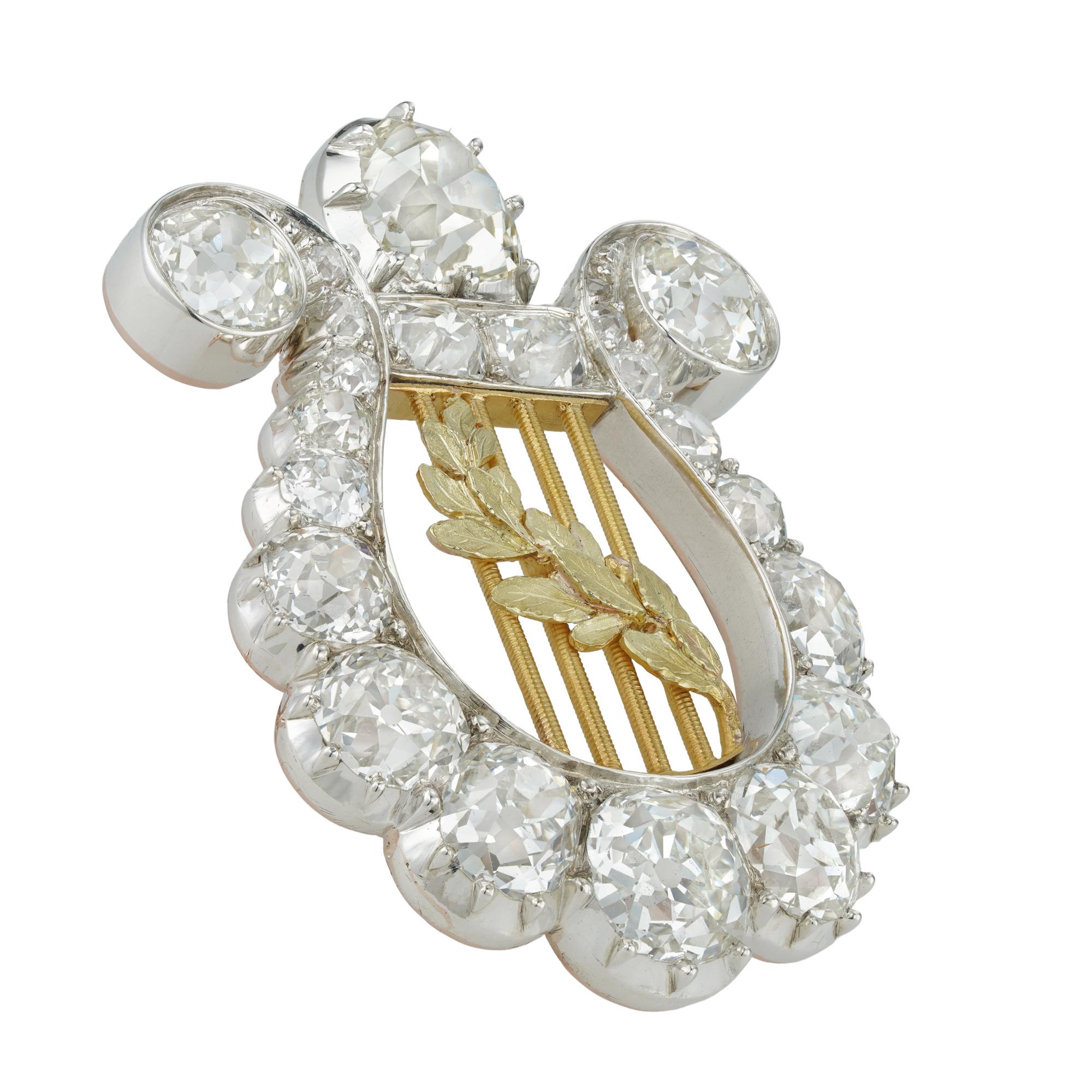 A Victorian diamond lyre brooch, set throughout with old brilliant-cut diamonds estimated to weigh a total of 7.2 carats, the centre with laurel leaf motif to gold strings, all set in silver to a yellow gold mount, circa 1880, gross weight 7.61
