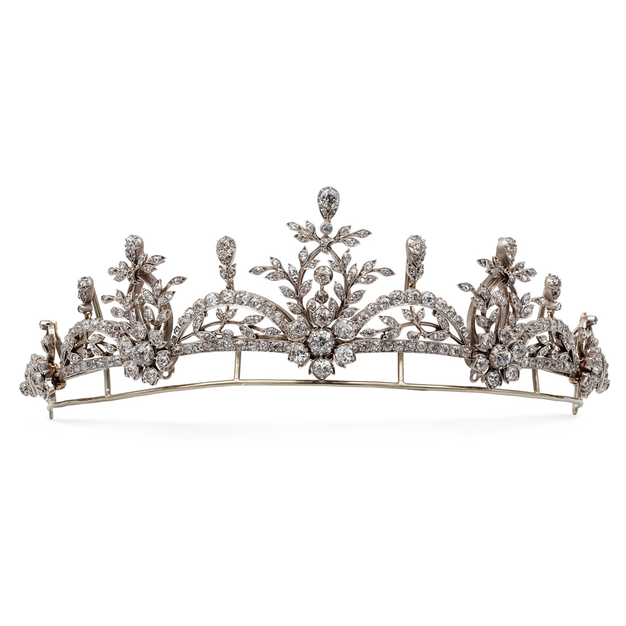 A late Victorian diamond-set tiara of floral design,  consisting of five diamond-set flowers with openwork folate design decorations graduating from the centre, connected with four openwork arches with foliate decorations, the three hundred and