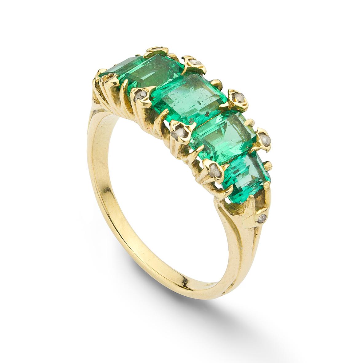 A late Victorian emerald five stone ring, the five emerald-cut emeralds graduated from the centre, estimated to weigh a total of 2.5 carats, claw set with a rose-cut diamonds in between and to the shoulders, all to a 18ct gold mount, cica 1900, head