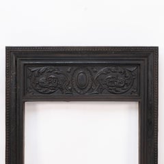 A late Victorian fireplace with stylized floral details to the top