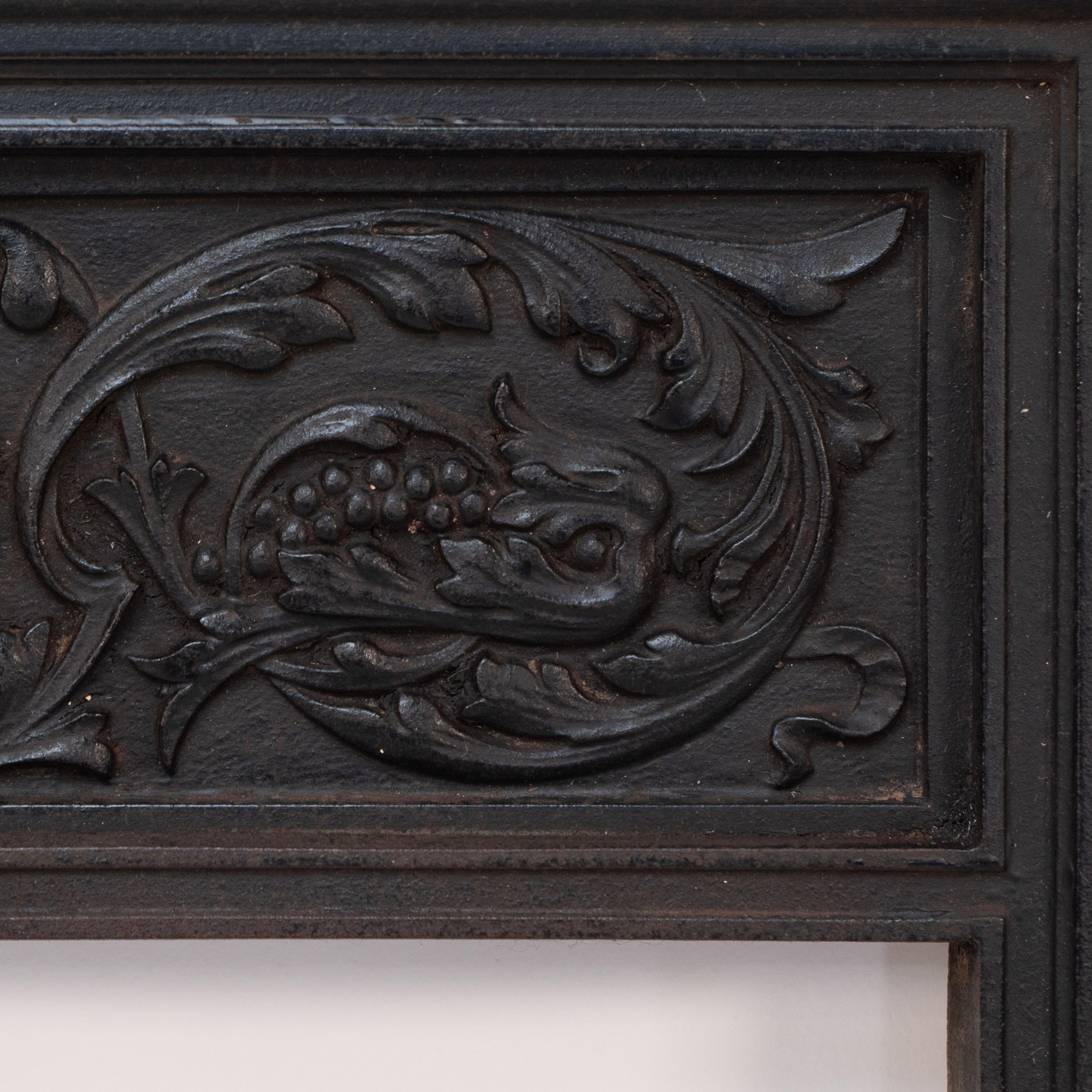 Late 19th Century A late Victorian fireplace with stylized floral details to the top For Sale