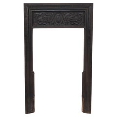 Antique A late Victorian fireplace with stylized floral details to the top