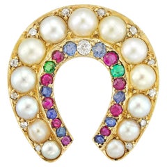 A late Victorian half-pearl and multi-gem horseshoe brooch