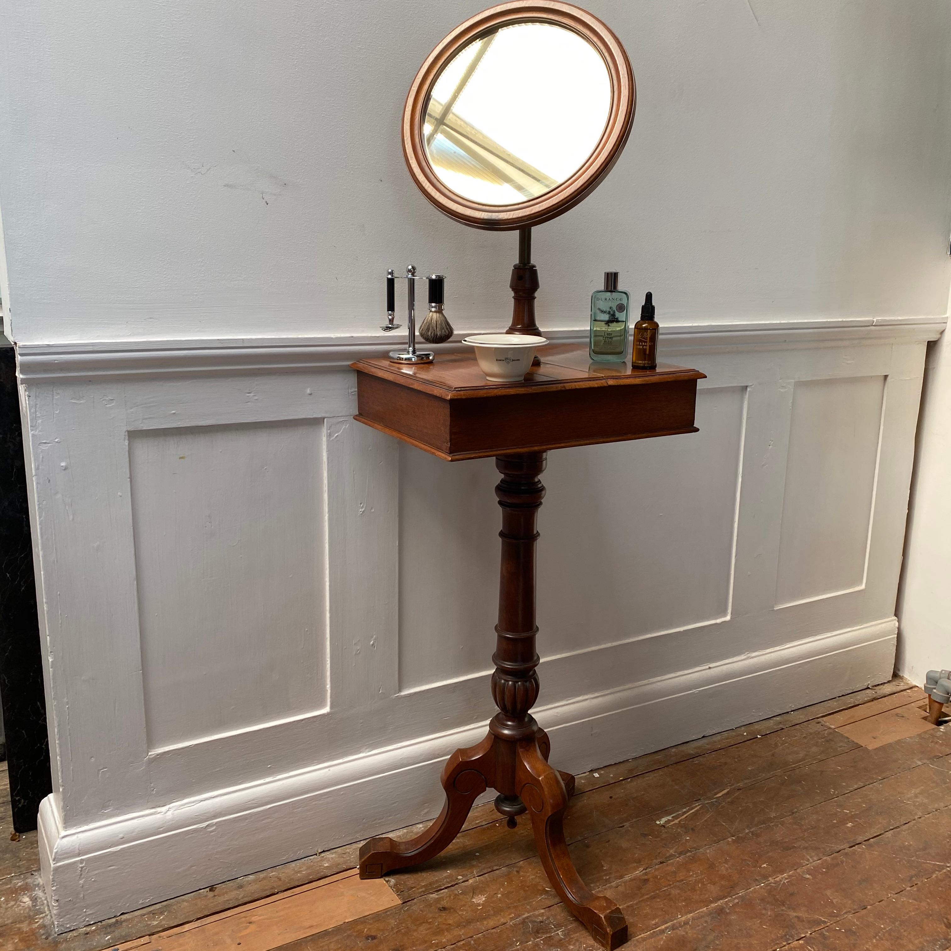 A handsome late Victorian mahogany shaving stand. Having an adjustable circular beveled mirror sitting in an attractive stepped frame. The mirror is attached to a brass upright with adjustable angle mechanism. The upright is sheathed in a turned