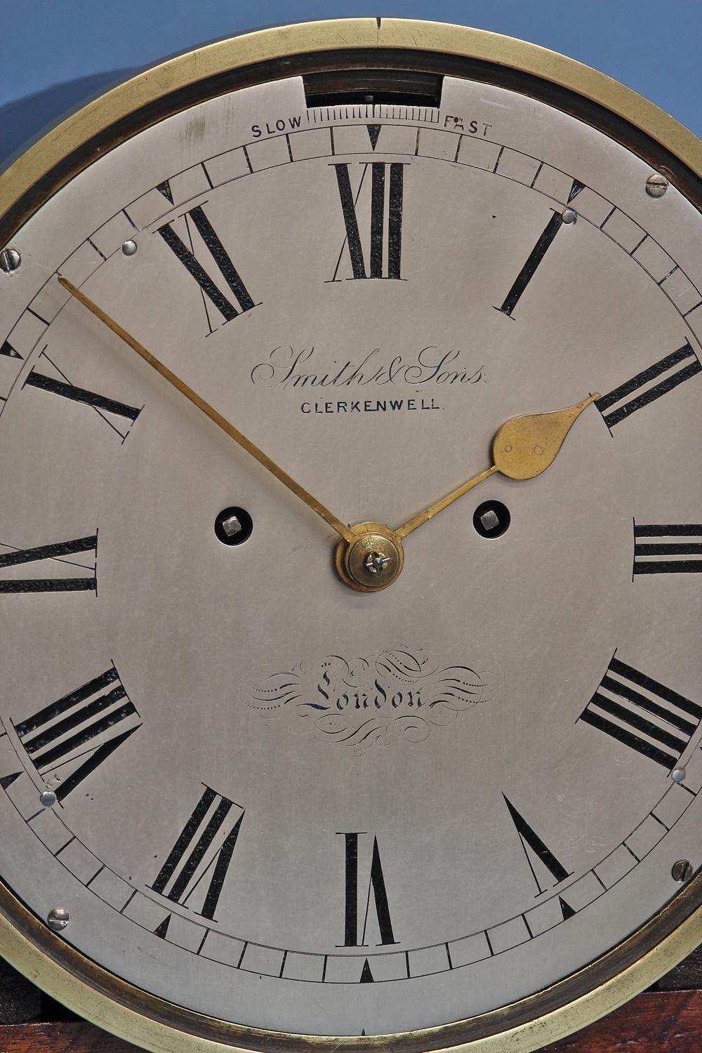A very rare late 19th century ship’s clock by Smith and Sons that strikes true nautical time incorporating the unique striking sequences for the ‘dog watches’ on two massive bells.

Case: 
The brass cylindrical case has a fretted aperture on the