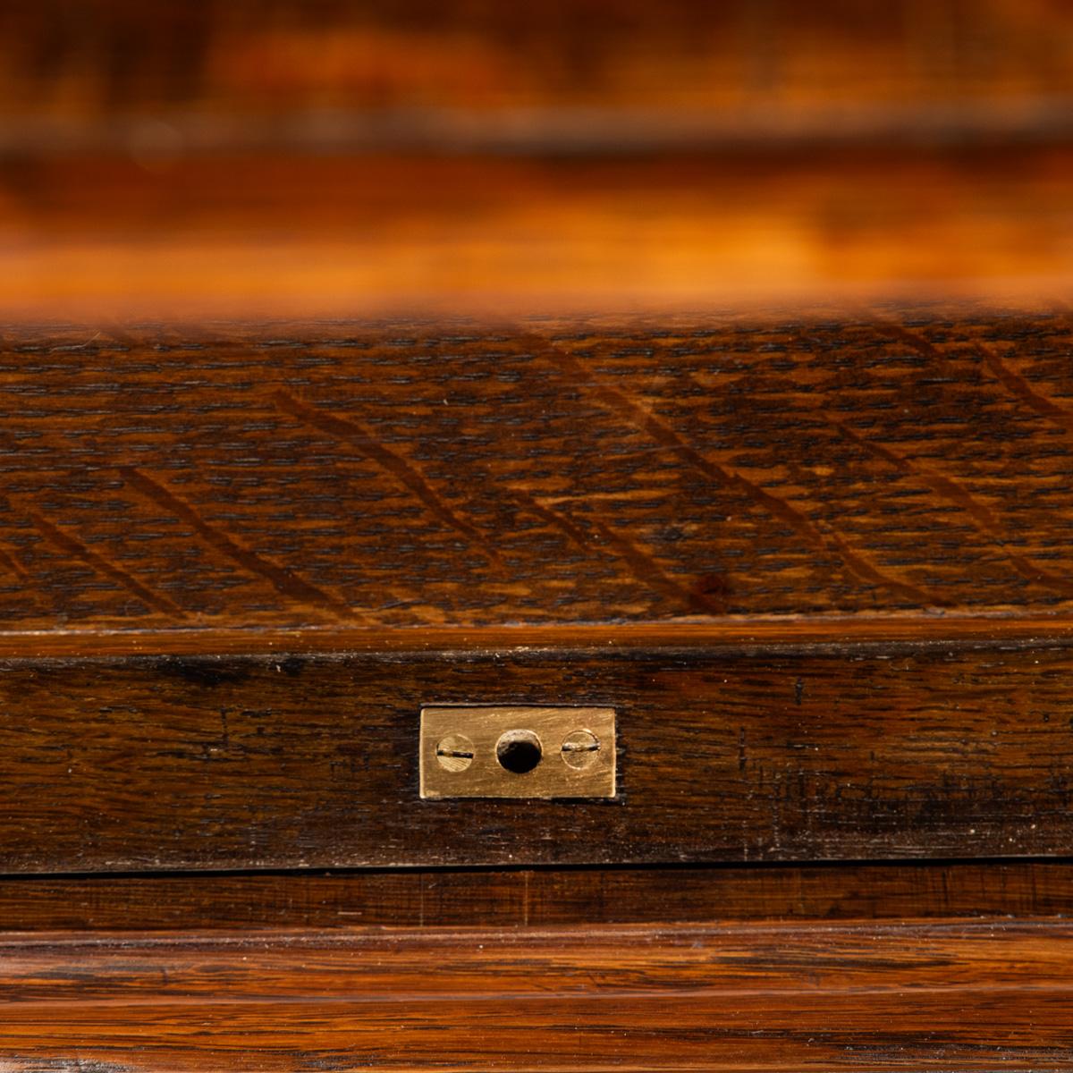 20th Century A late Victorian oak gun cabinet