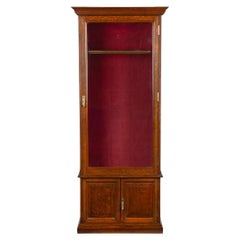 A late Victorian oak gun cabinet