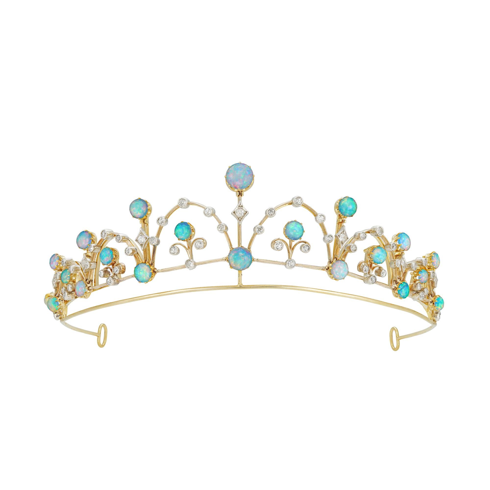 A late Victorian opal and diamond tiara/necklace, consisting of seven knife-edge gold bars graduating from the centre, each set with two round cabochon-cut opals and an old-cut diamond in-between, the bars connected with six diamond-set arches each