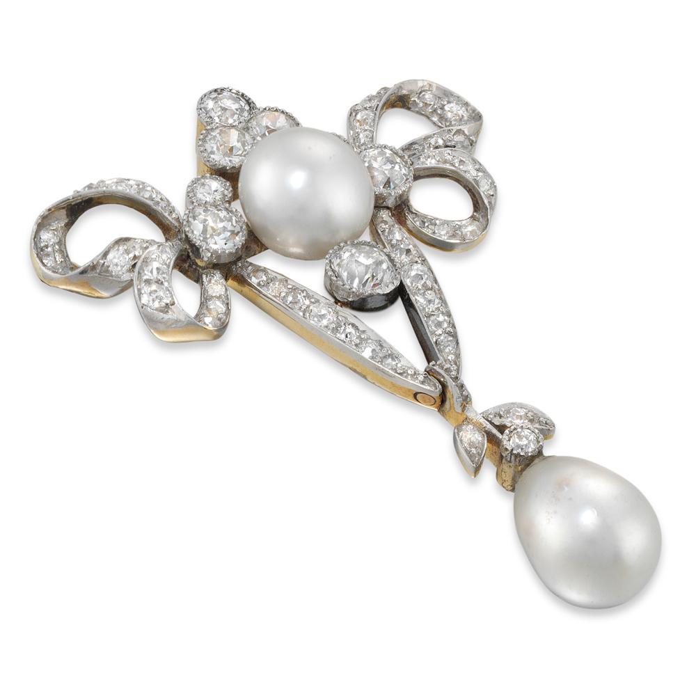 A late Victorian pearl and diamond brooch, the brooch with a diamond-set ribbon bow surmount, set to the centre with a pearl and diamond cluster, the pearl measuring approximately 8 mm in diameter, dropping a natural pear-shaped pearl measuring