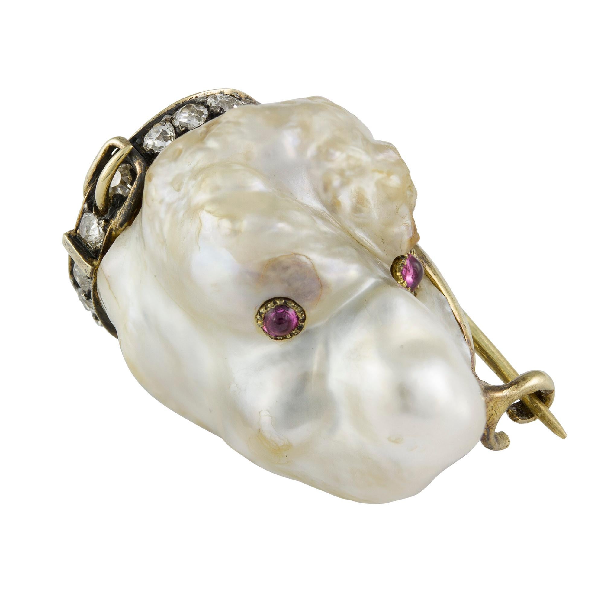 A late Victorian pearl, gem set and diamond dog brooch, the natural blister pearl dog shaped pearl, accompanied by a GIA certificate, with cabochon-cut ruby eyes and old brilliant-cut diamond-set collar to a closed back gold mount with brooch pin