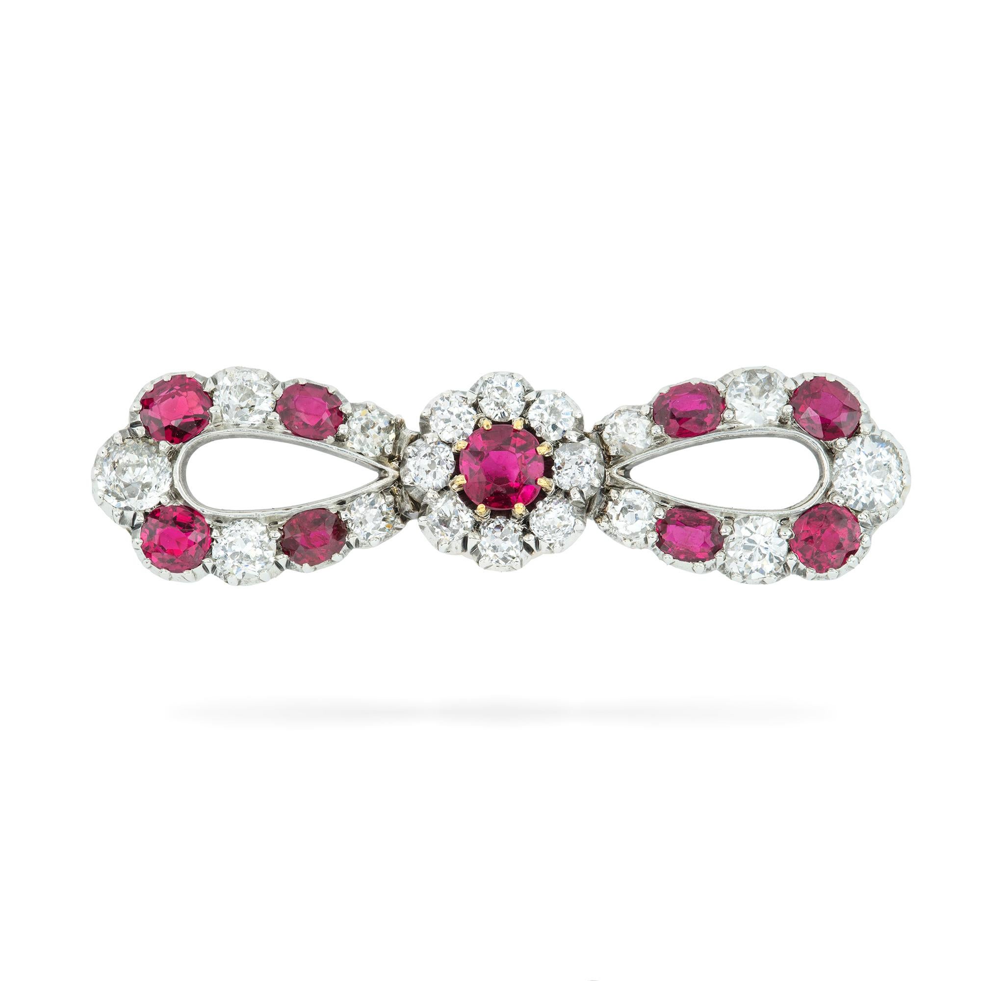 A late Victorian ruby and diamond bow brooch, the centrally set ruby surrounded by an old-cut diamond-set cluster, bow parts alternately-set with graduated round faceted rubies and old brilliant-cut diamonds, the rubies estimated to weigh 0.8 carats