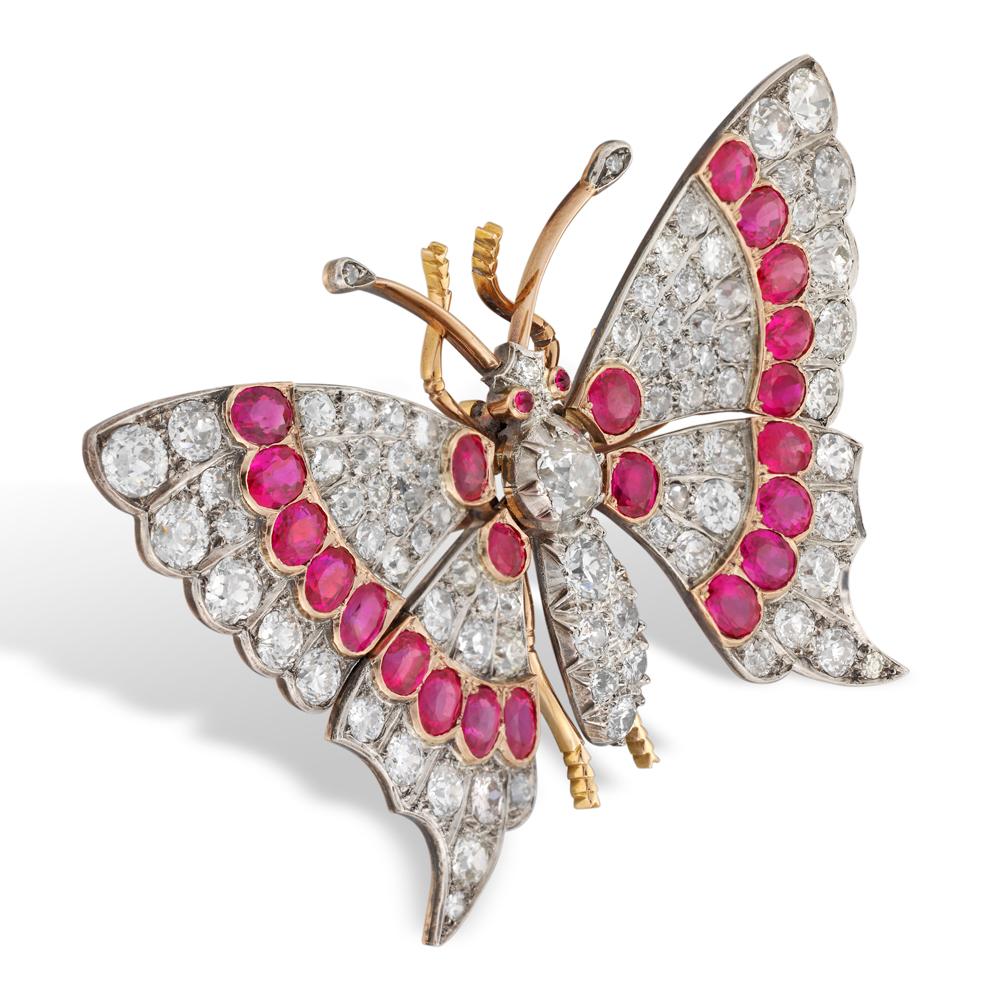 A late Victorian ruby and diamond brooch in the form of a butterfly, with the wings set en tremblant, total diamond weight estimated 14 carats, total rubies weight estimated 12 carats, to a silver and yellow gold mount, circa 1860, measuring 6.4 x
