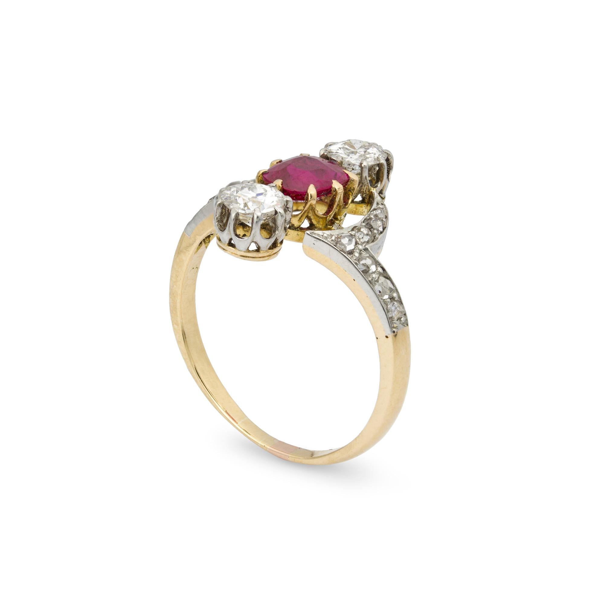 A late Victorian ruby and diamond ring, the central oval-cut ruby weighing 0.61cts with two old brilliant-cut diamonds to top and bottom, linked by diamond-encrusted crescent motifs and diamond-set shoulders, the diamonds estimated to weigh a total