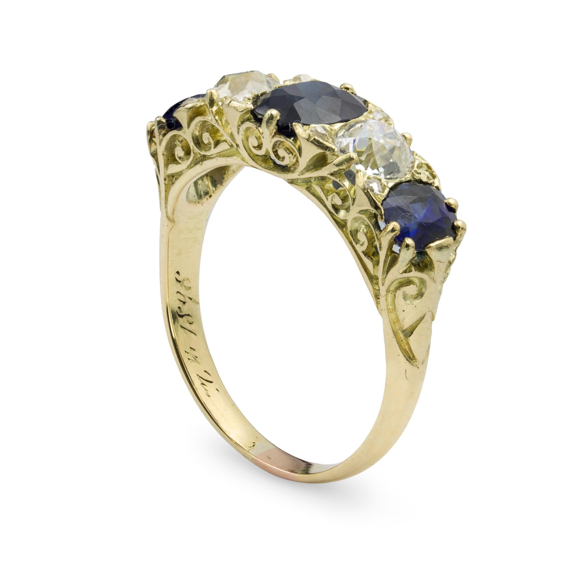 A late Victorian sapphire and diamond five stone ring, set with three cushion-shaped sapphires with total weight 2.58 carats, alternating with two old brilliant-cut diamonds with total weight 1.0 carat, claw set in carved and pierced yellow gold