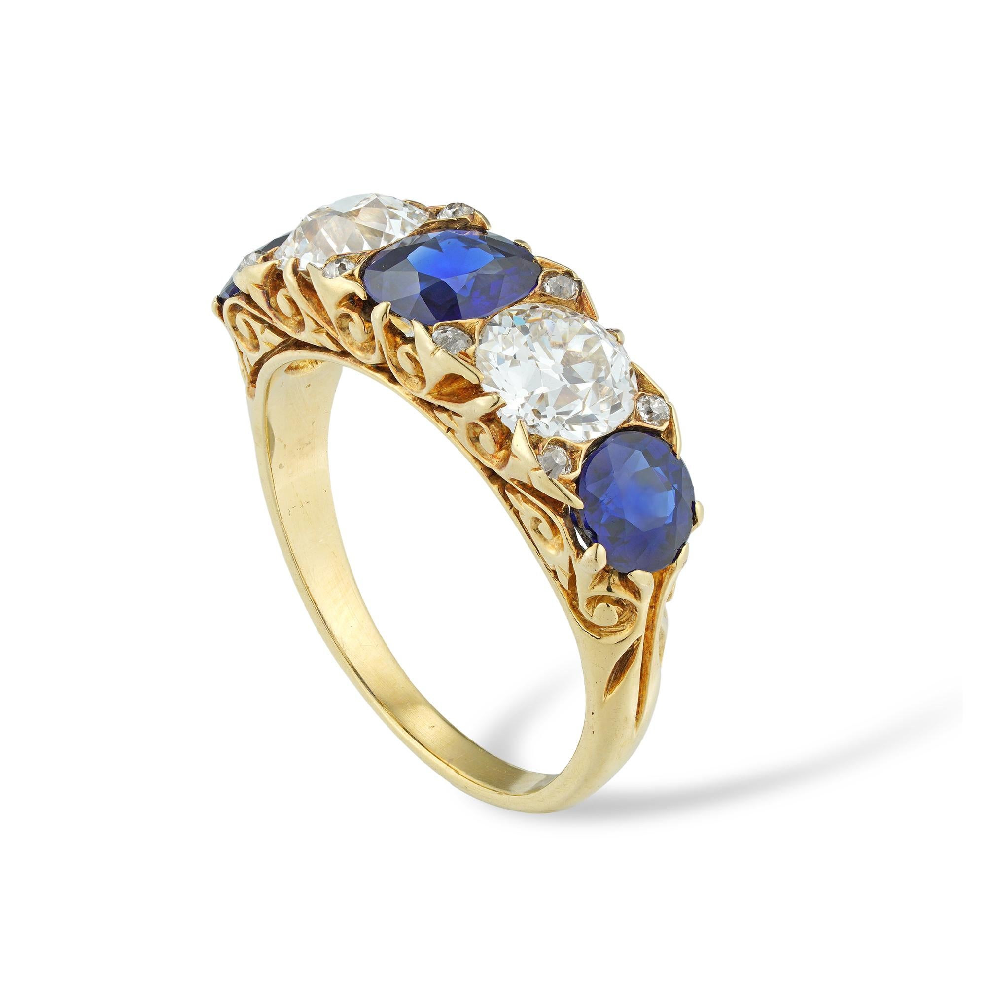 A late Victorian sapphire and diamond five-stone ring, set with three cushion-shaped sapphires estimated to weigh 2.25 carats, alternating with two old European-cut diamonds estimated to weigh 1.7 carats in total, claw-set in yellow gold mount with