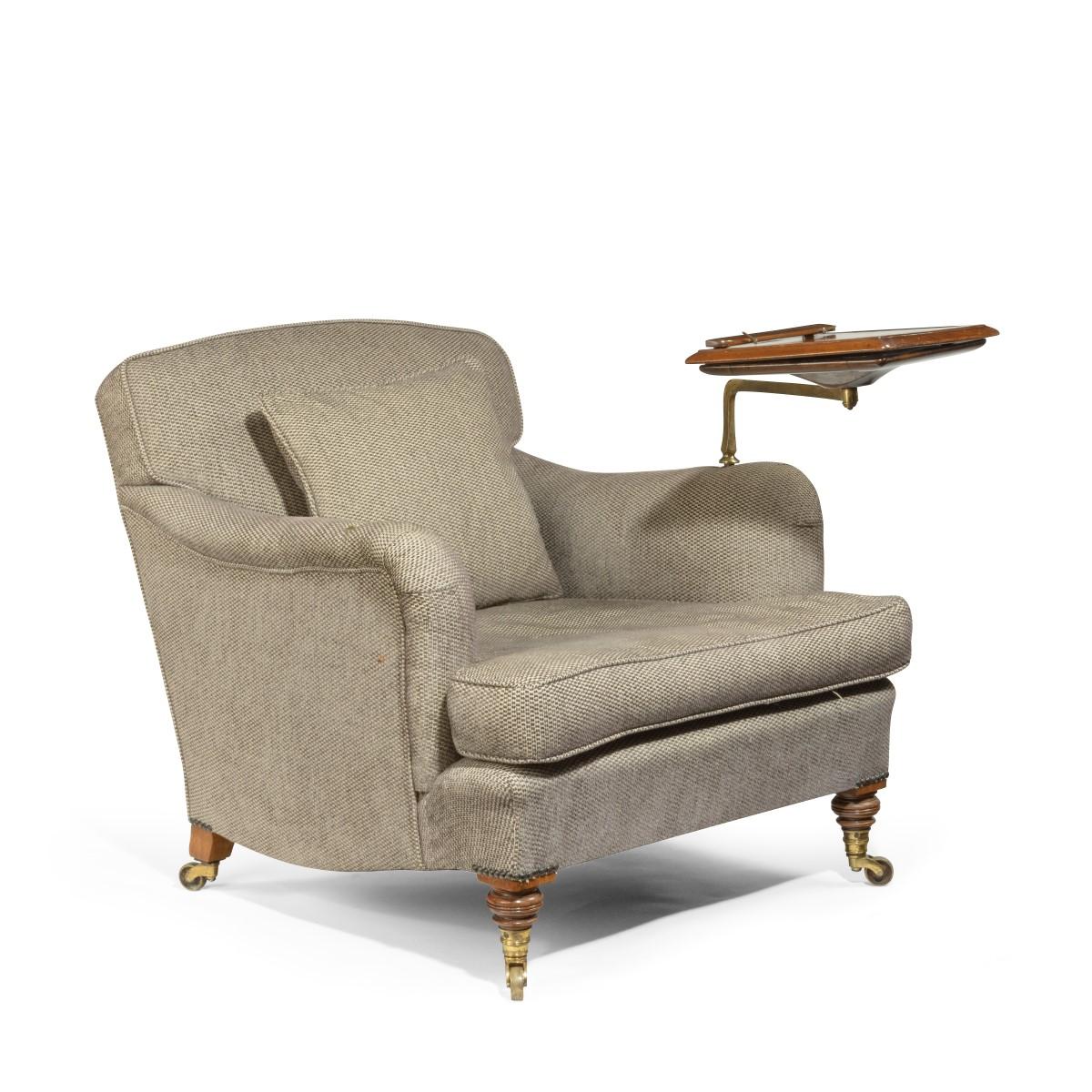 A late Victorian walnut library arm chair by Howard & Sons, the deep armchair fully upholstered over the back and scrolling, padded arms and shaped cushion, the front legs turned, one stamped on the castor ‘Howard & Sons, London’ feet, one back leg