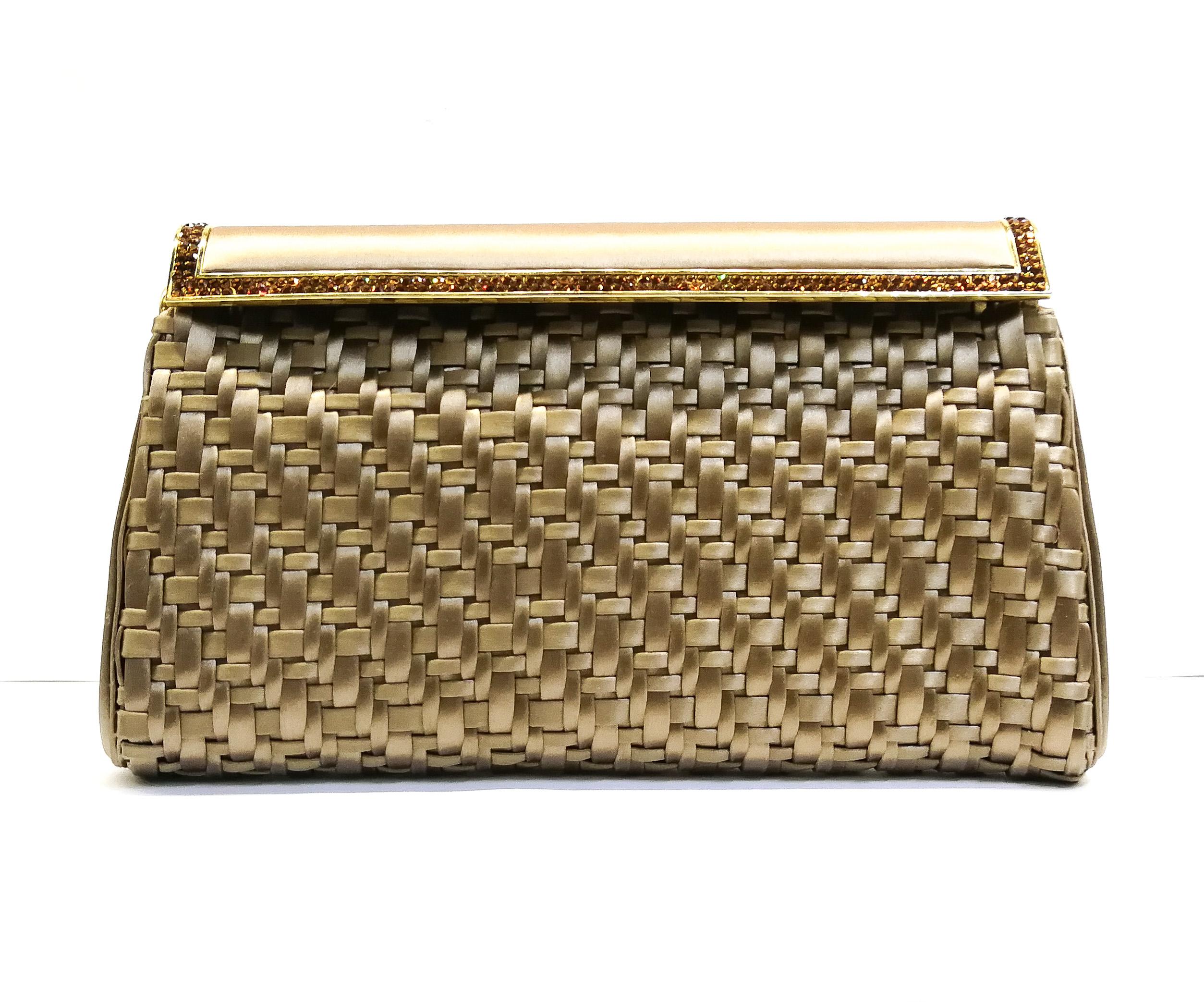 A very smart and elegant evening bag from Judith Leiber in the 1980s, made of 'woven/plaited' or 'latticed' bands of coffee coloured/soft bronze silk, set off against dark topaz rhinestones edging the gilt metal and silk sprung clasp/closure. It is
