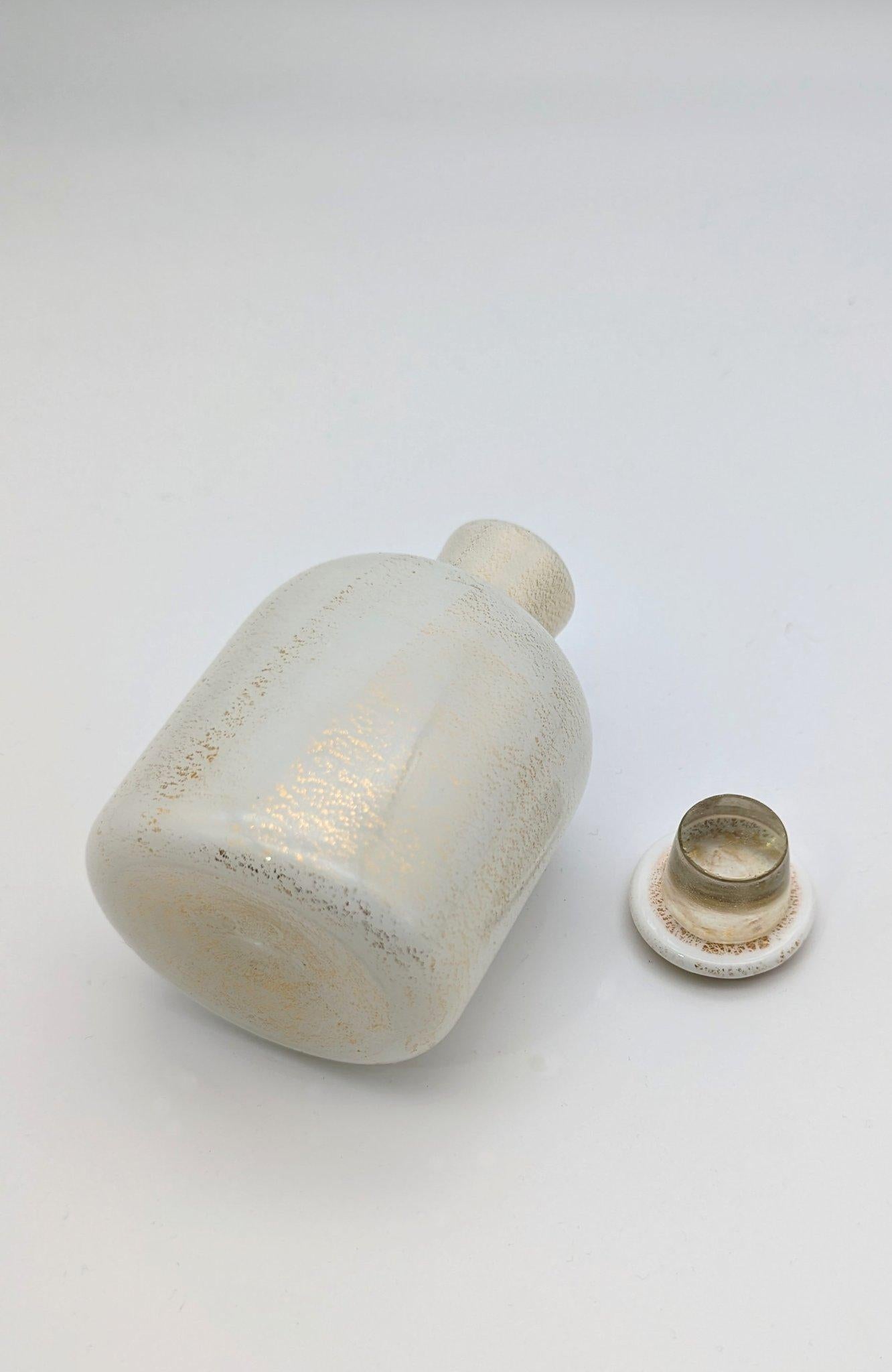 A straight forward design by Carlo Scarpa. The shape of the bottle is for the Venini dressing table set 653. Presented on the Brussels Arts and Crafts Exhibition in 1935. This bottle came in variations of  three separately designed stoppers, here