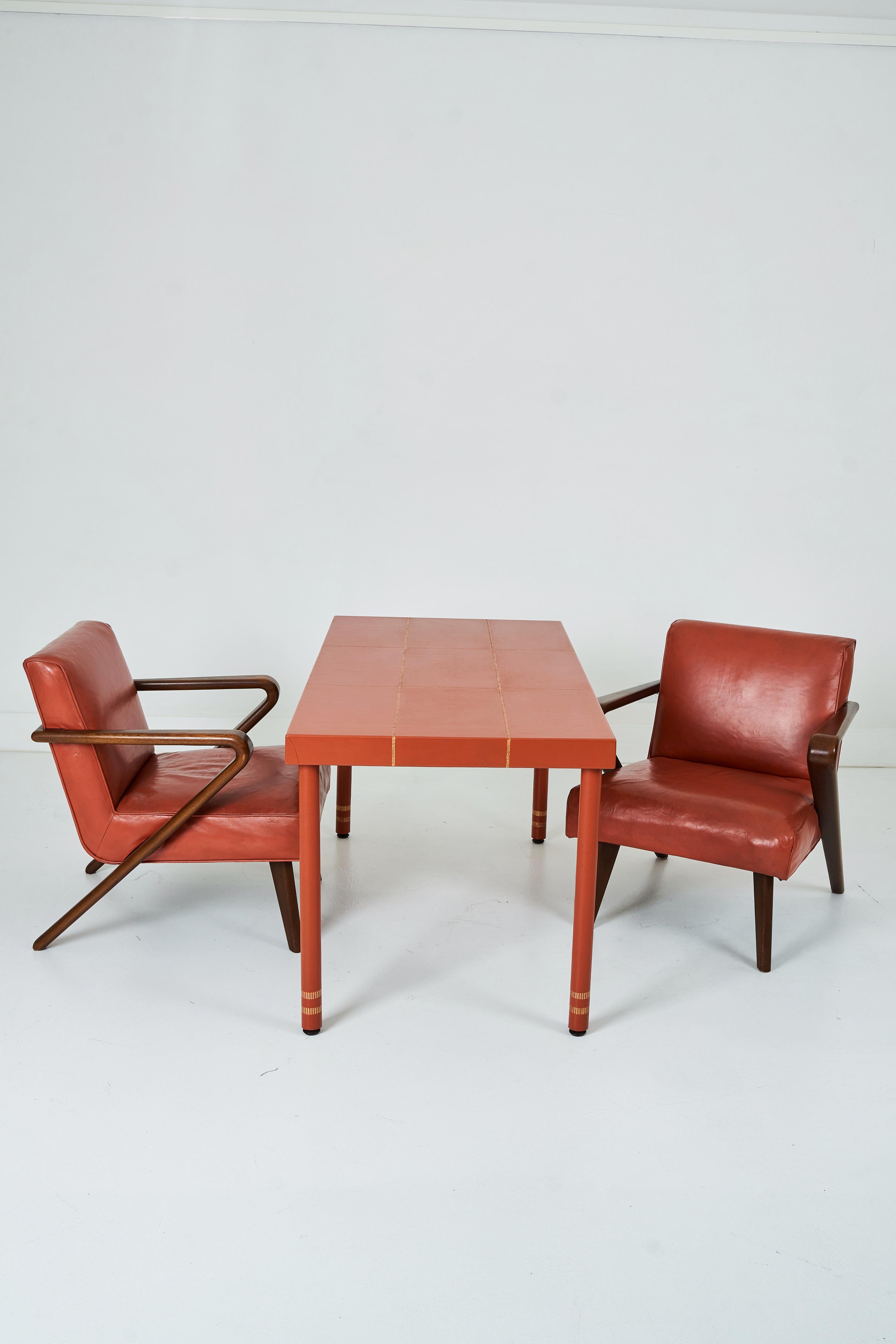 A Leather Wrapped Desk and Matching Arm Chairs designed by William Haines 1