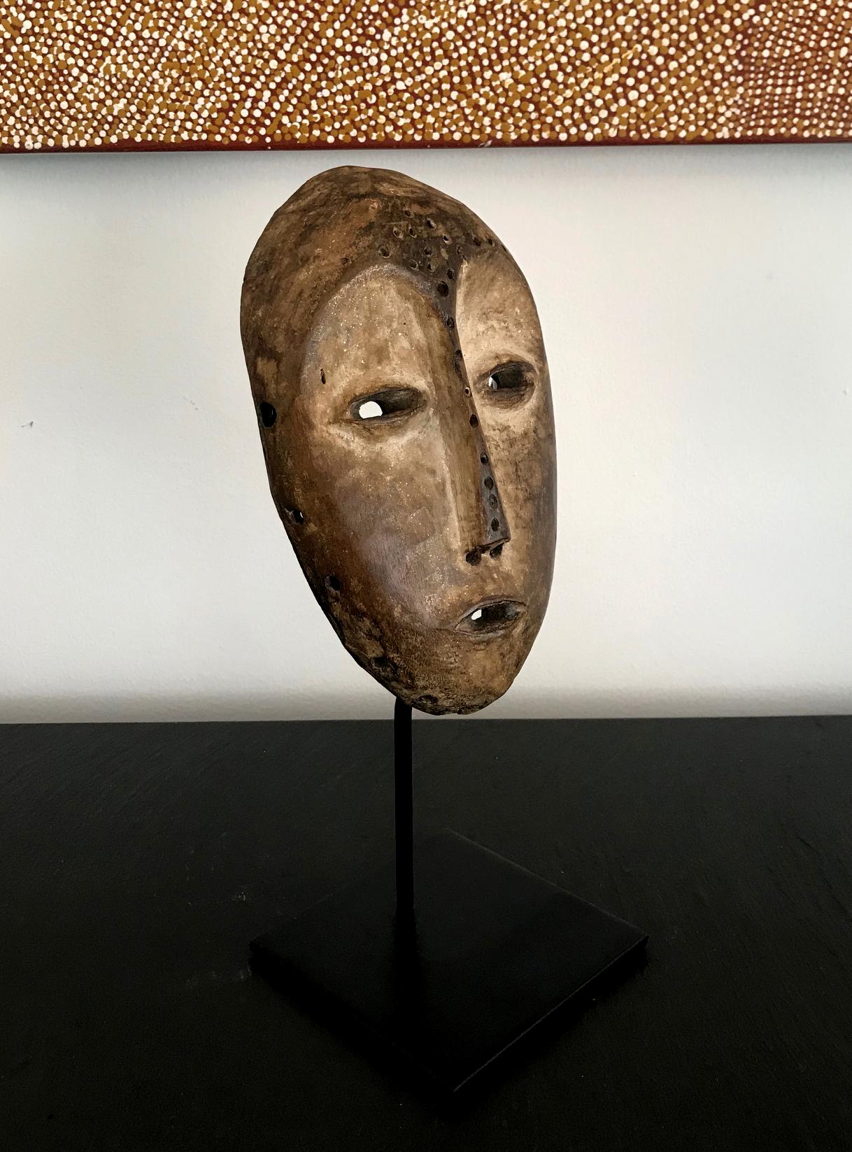 On offer is a Lega Bwami society wooden mask from the Democratic Republic of the Congo. It was likely from the first half of the 20th century and an authentic in-field piece. The mask displays a nice patina on both the front and back sides, and the