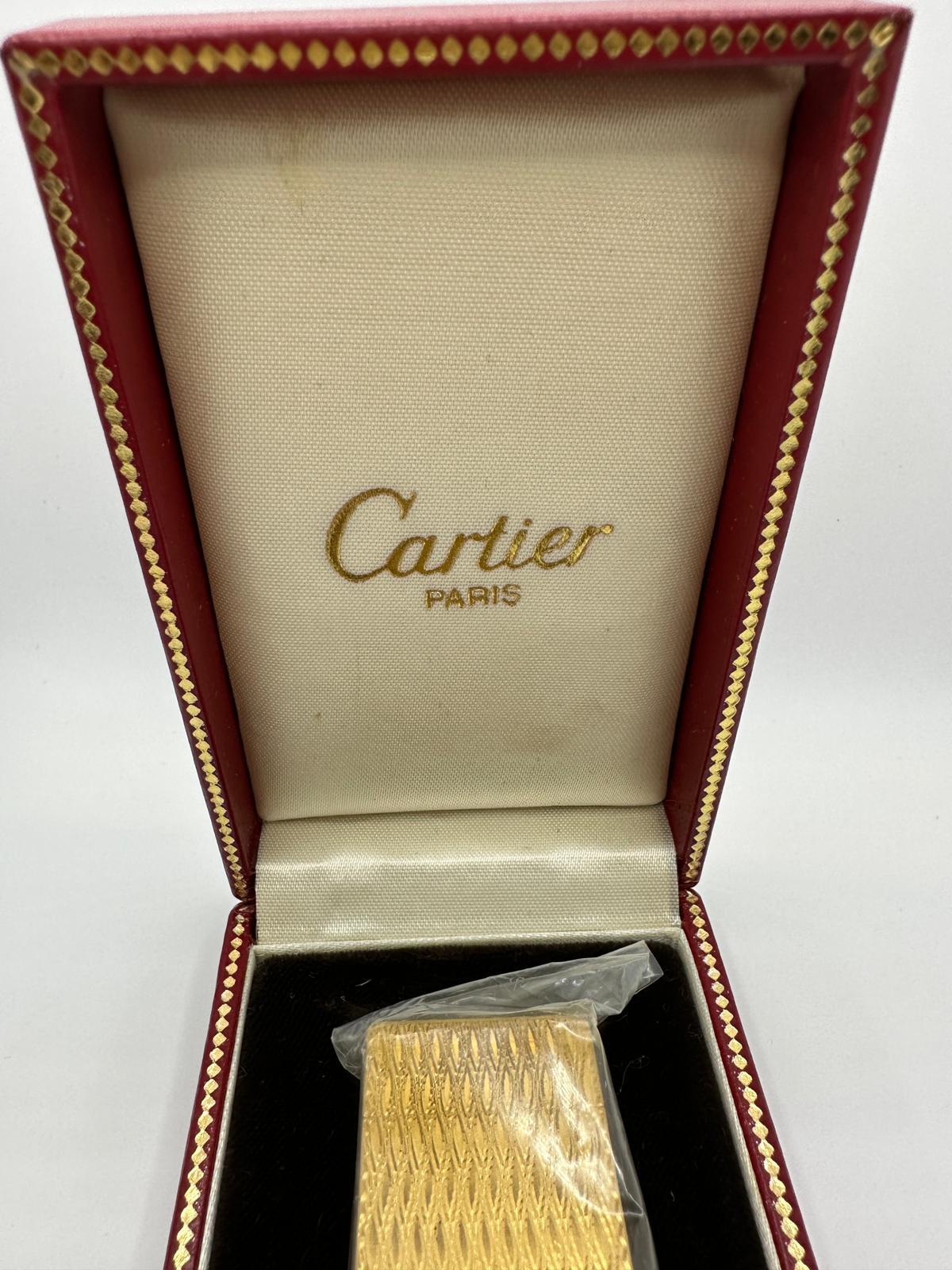 Vintage and Retro Cartier gold plated lighter  A Les Must De Cartier Paris 18k gold plated lighter Retro, elegant and chic  In mint working condition, sparks, ignites and flame.
Comes with original Cartier box and certificate. 
I do not think it has