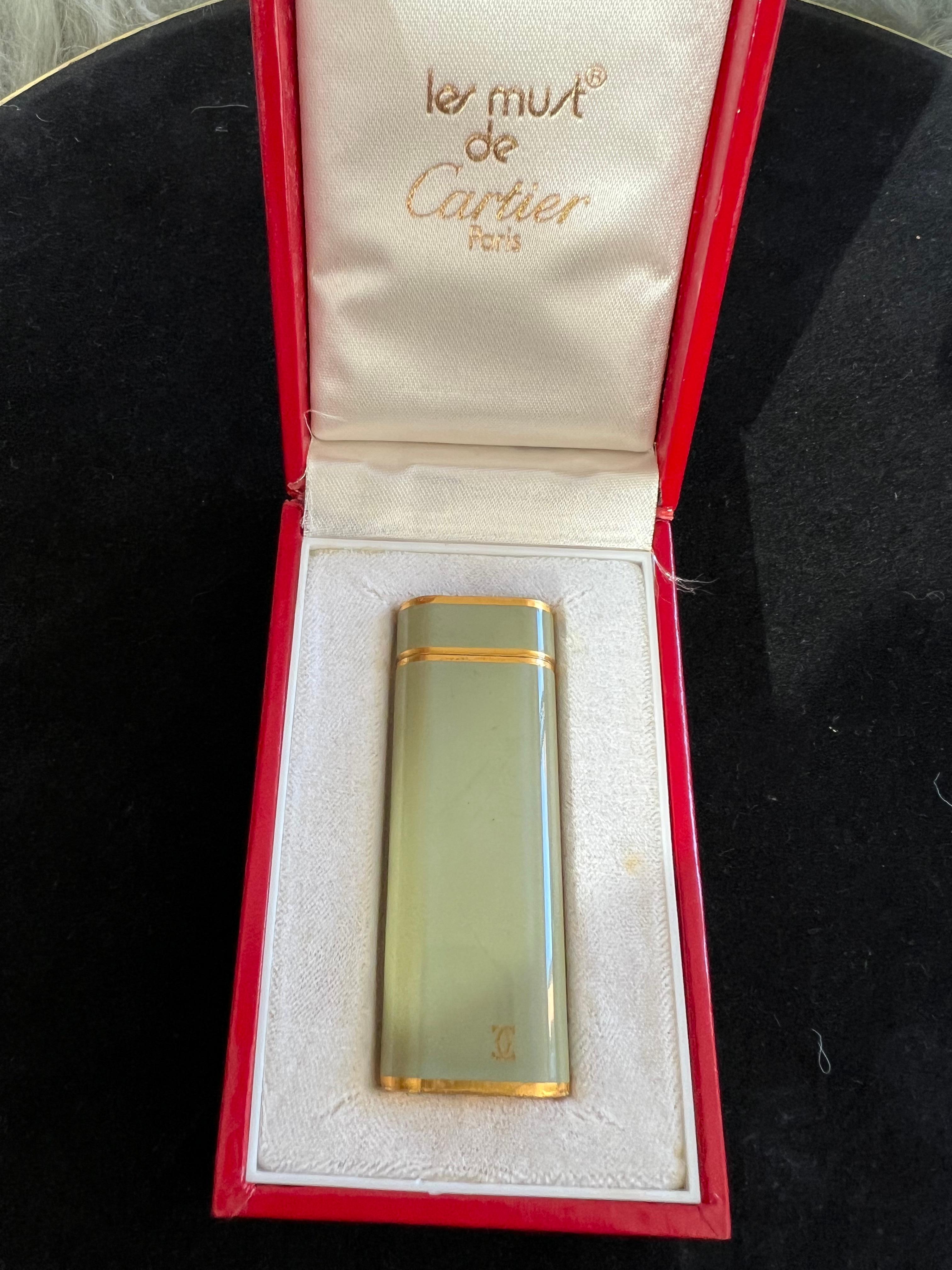 A Les Must De Cartier Paris 18k gold plated and Olive Chinese lacquer lighter 7