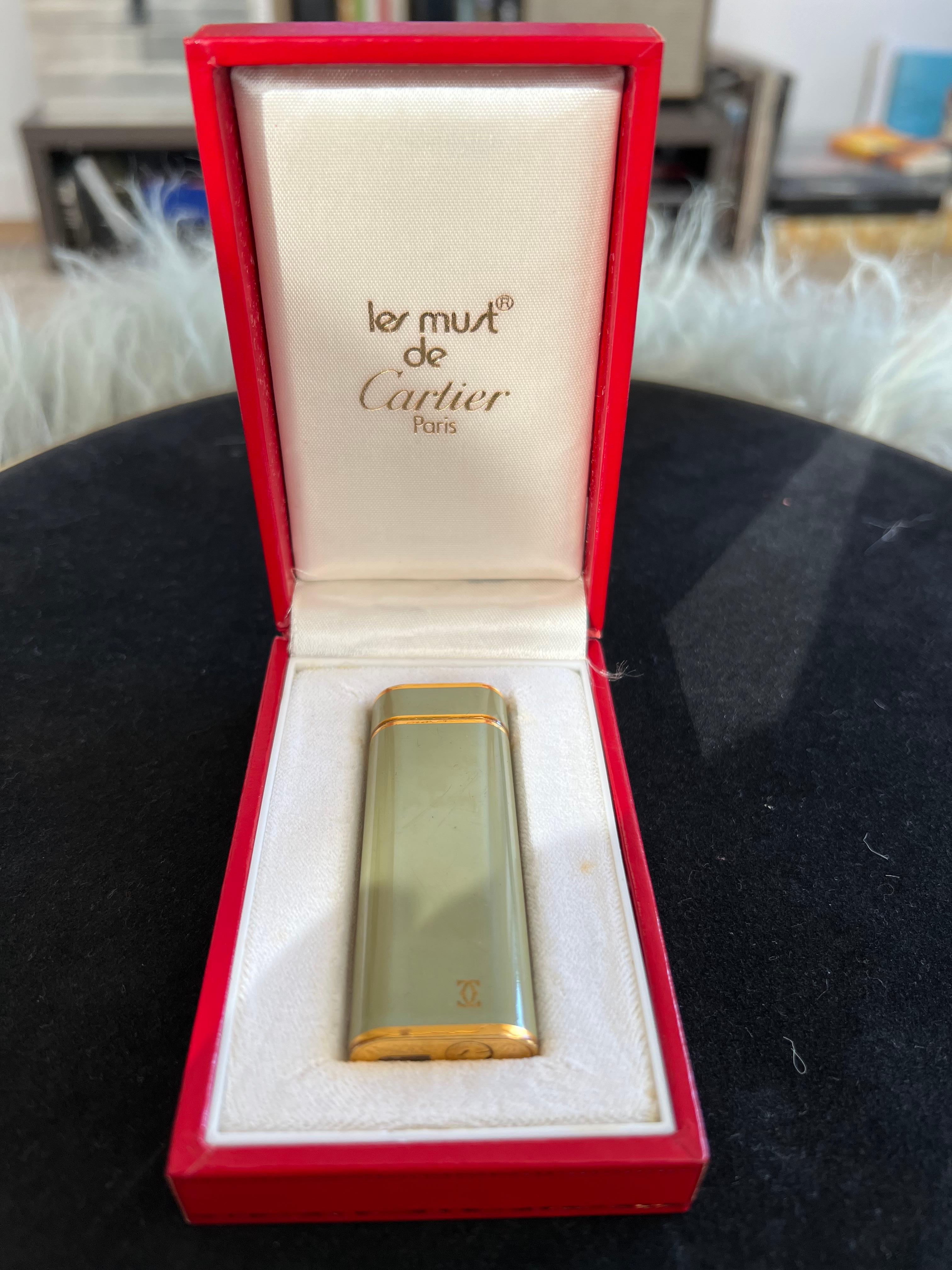 A Les Must De Cartier Paris 18k gold plated and Olive Chinese lacquer lighter 9