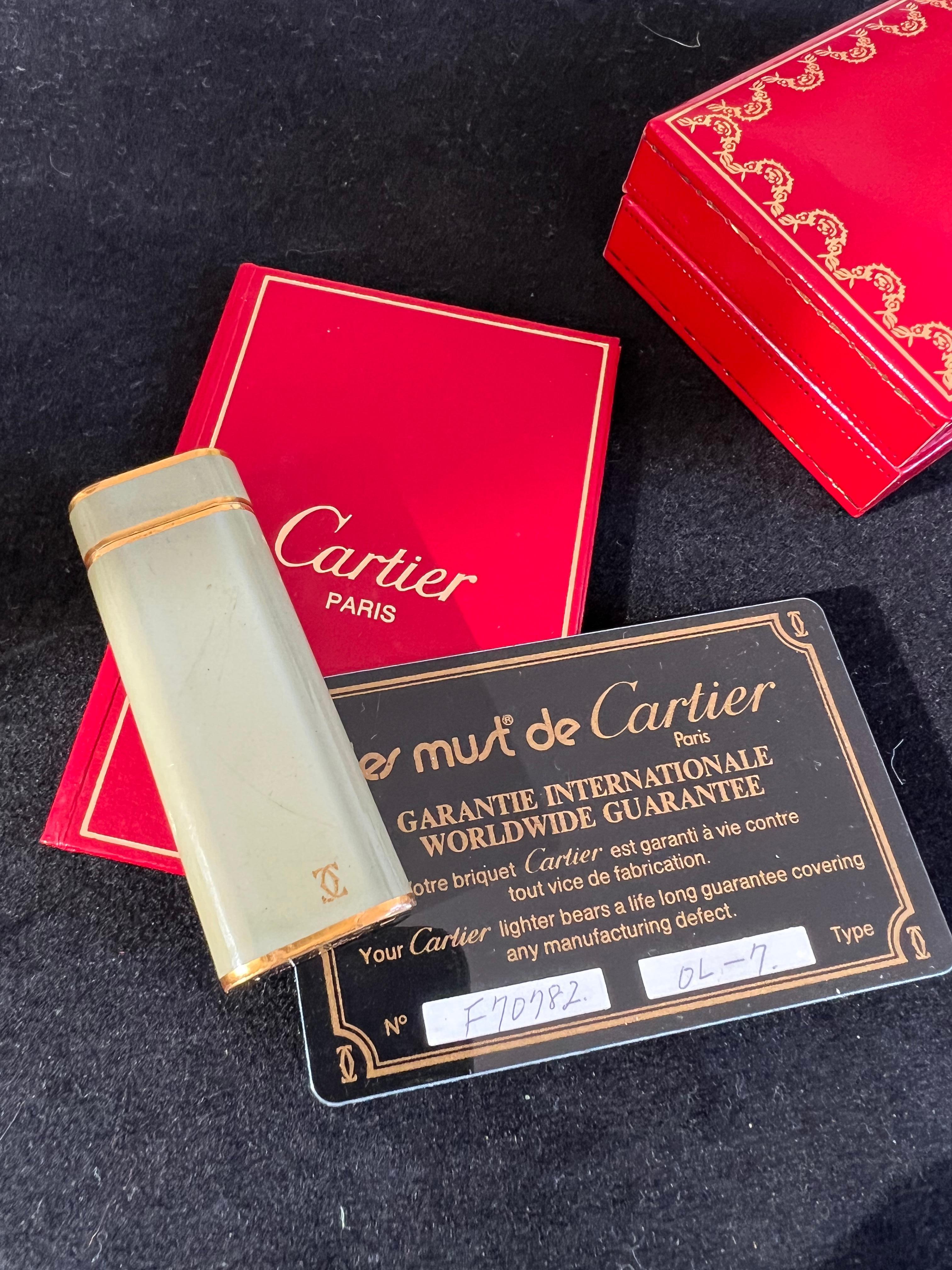A Les Must De Cartier Paris 18k gold plated and Olive Chinese lacquer lighter 1