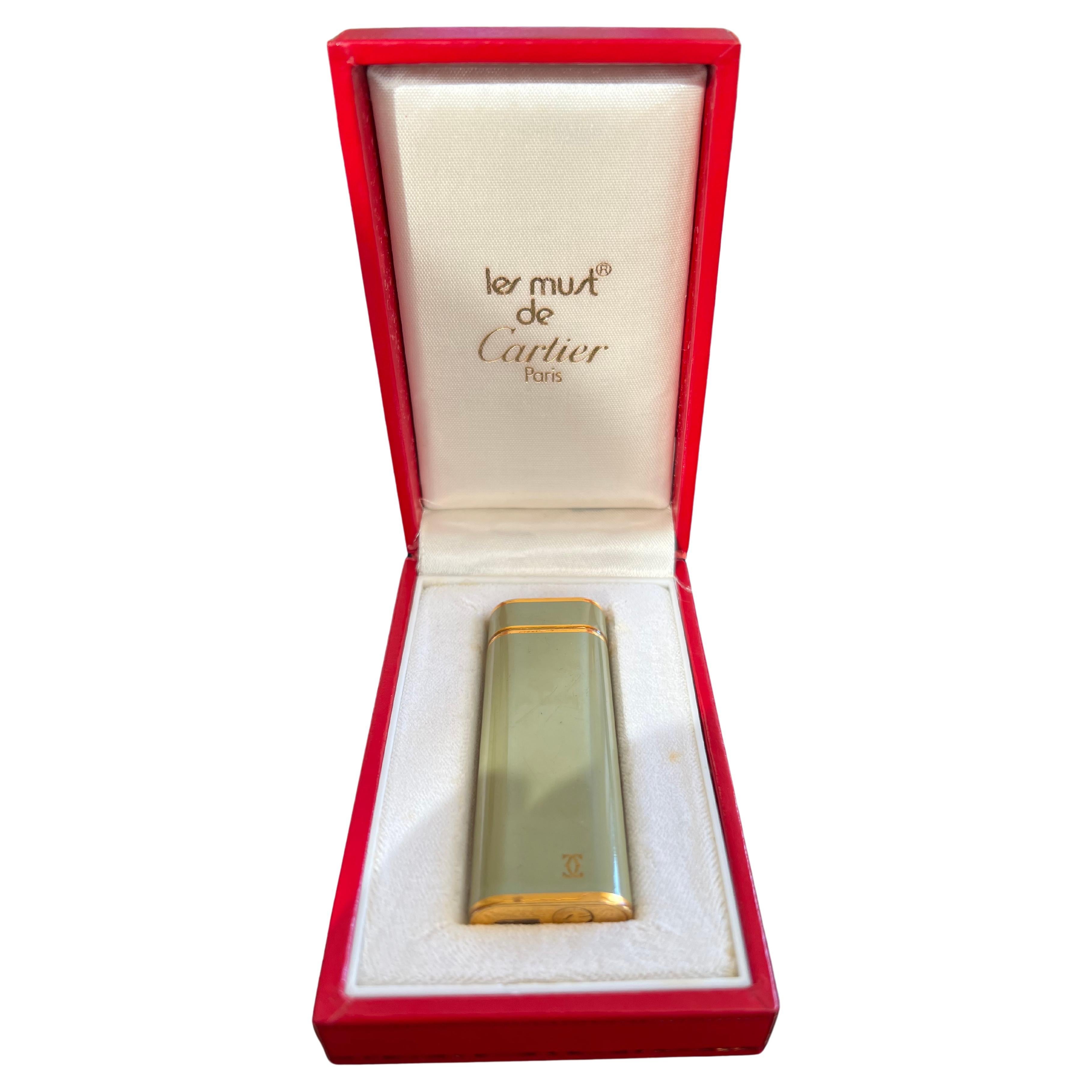A Les Must De Cartier Paris 18k gold plated and Olive Chinese lacquer lighter