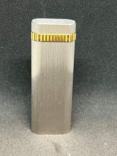 “Le Must De Cartier Paris” Platinum mate finish & 18k gold plated lighter