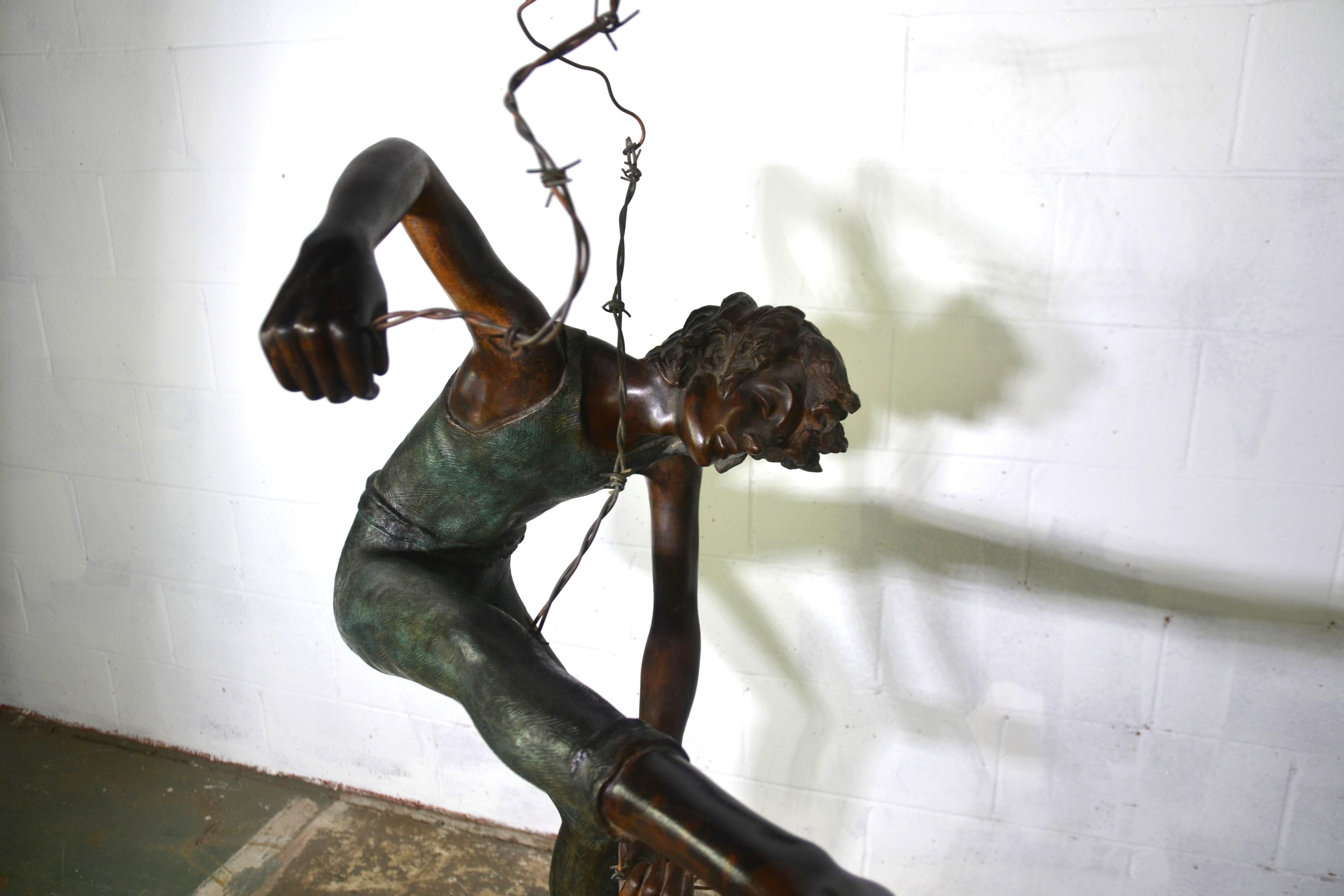 This is a life-size Bronze of a Boy tangled in a length of barbed wire. Really nice looking aged patina.  Weighted base