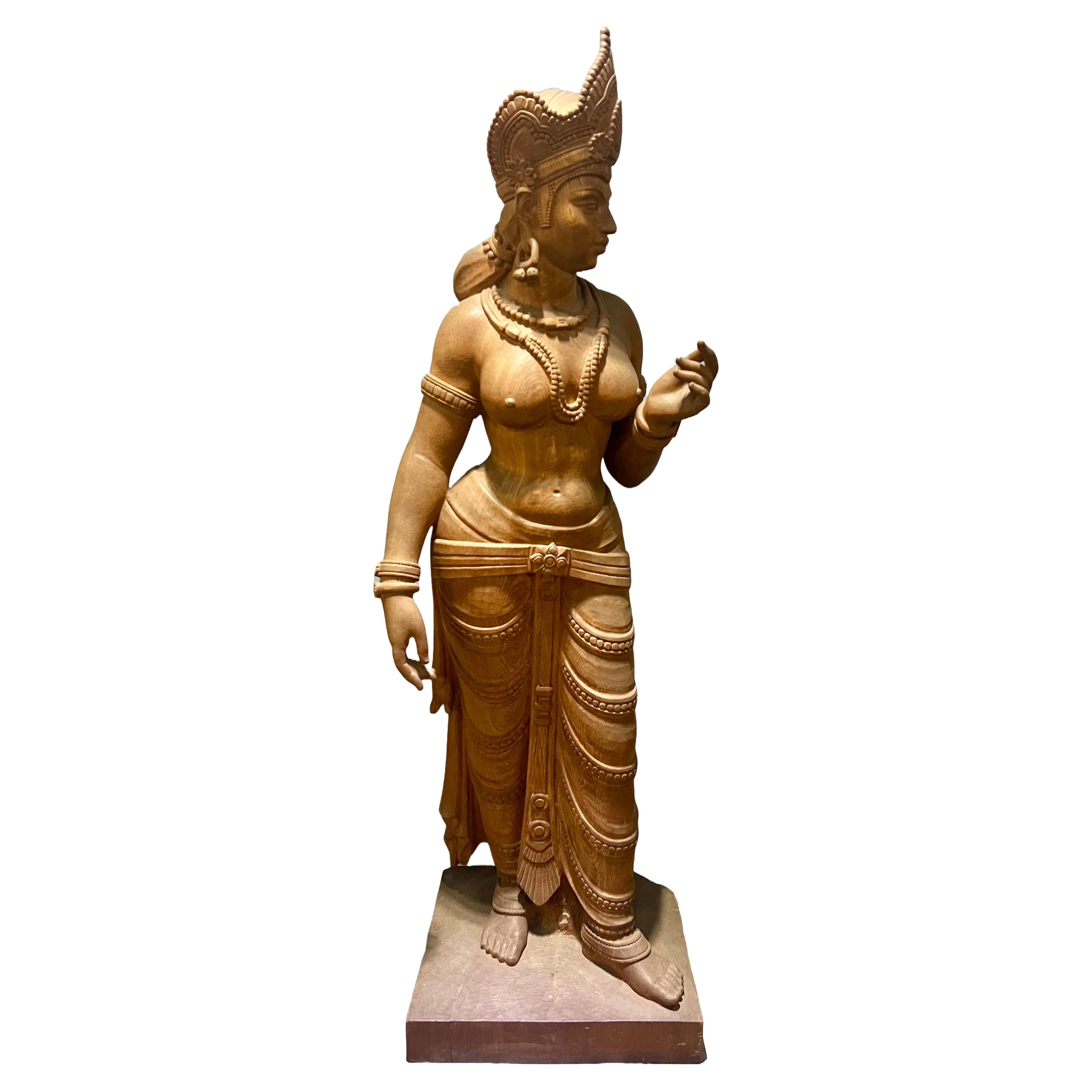 A life-size carved wood sculpture of the Hindu goddess Parvati