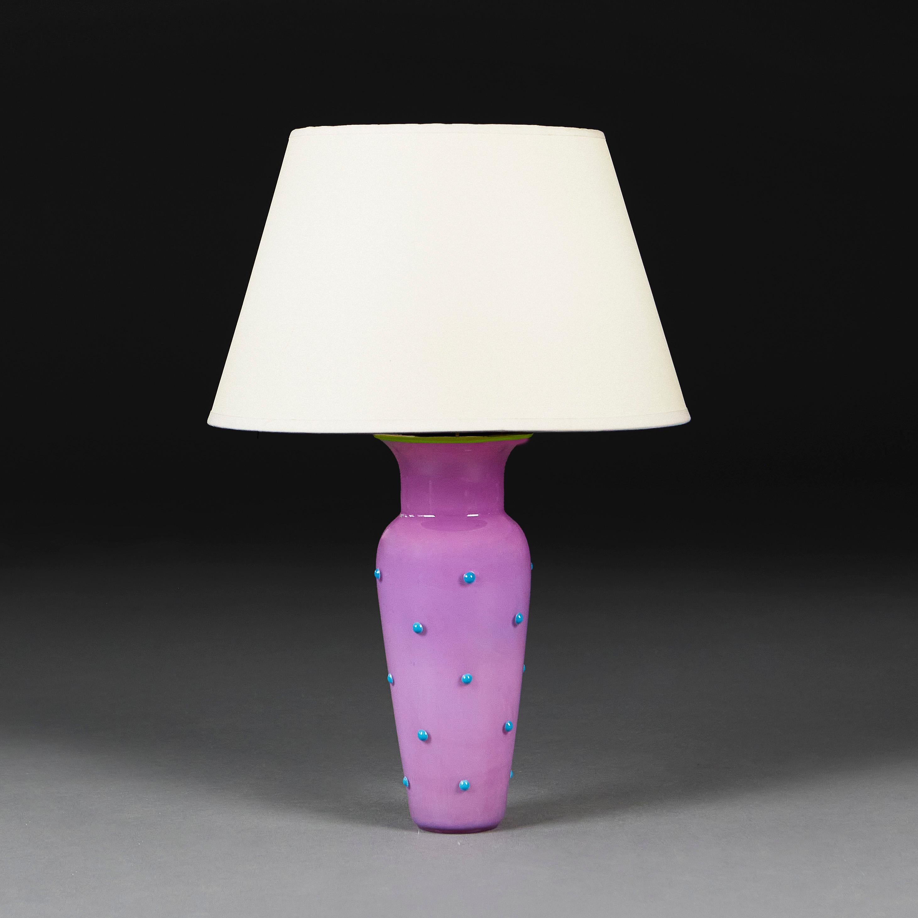 Italy, circa 1950
An unusual mid twentieth century Murano glass vase with lilac ground and blue polka dots, with vivid green rim, now as a lamp. 

Height of vase    30.00cm
Diameter of base   8.00cm

Please note:
Lamp has been photographed with a