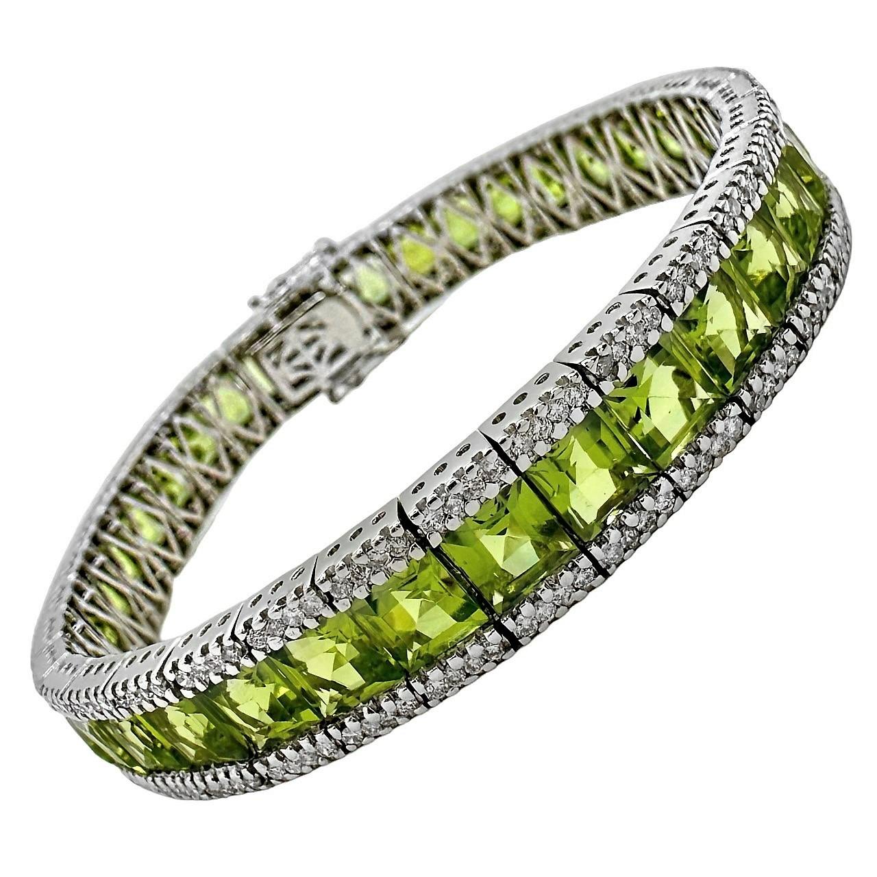 A ladies 18K white gold line bracelet, centered around 36 vivid green peridots, weighing a total of approximately 30ct. Flanking the beautiful row of chartreuse, are rows of round brilliant cut white diamonds, weighing a total of approximately