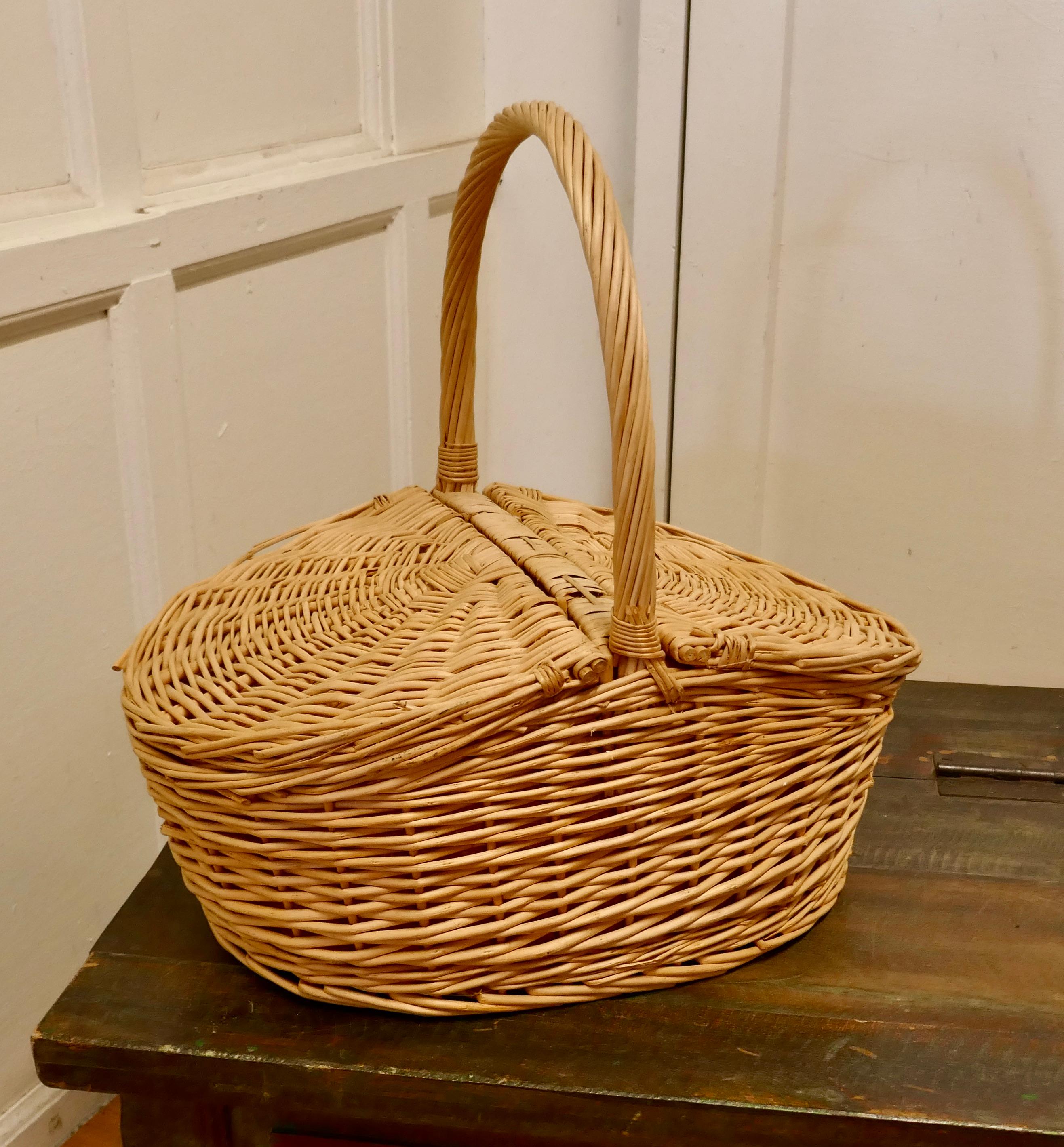A lined oval wicker picnic basket

An attractive basket with 2 lidded sections and big handle, the basket is lined inside
This is a lovely piece, decorative and useful storage it is sound with very little wear to the wicker 
The Basket is 20”