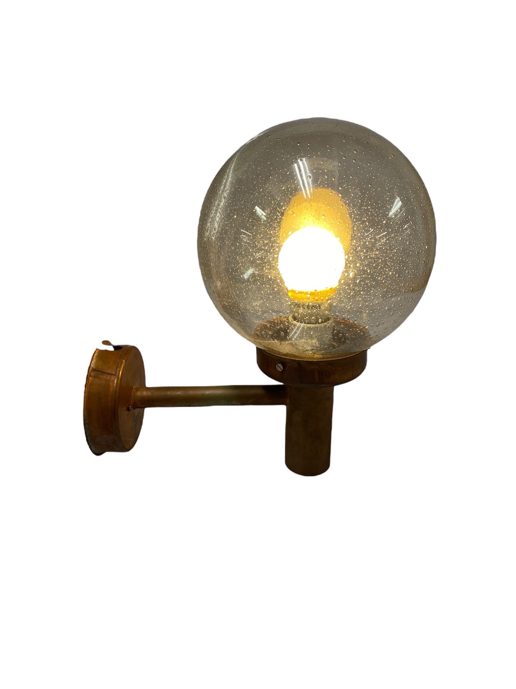 An outdoor wall lamp designed by Lisa Johansson-Pape and manufactured by Orno Oy, in the 1950s in Finland. In fully original condition featuring a nice patina. The item is stamped by the manufacturer 