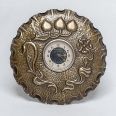 A little Arts & Crafts copper table clock in the shape of a flower head