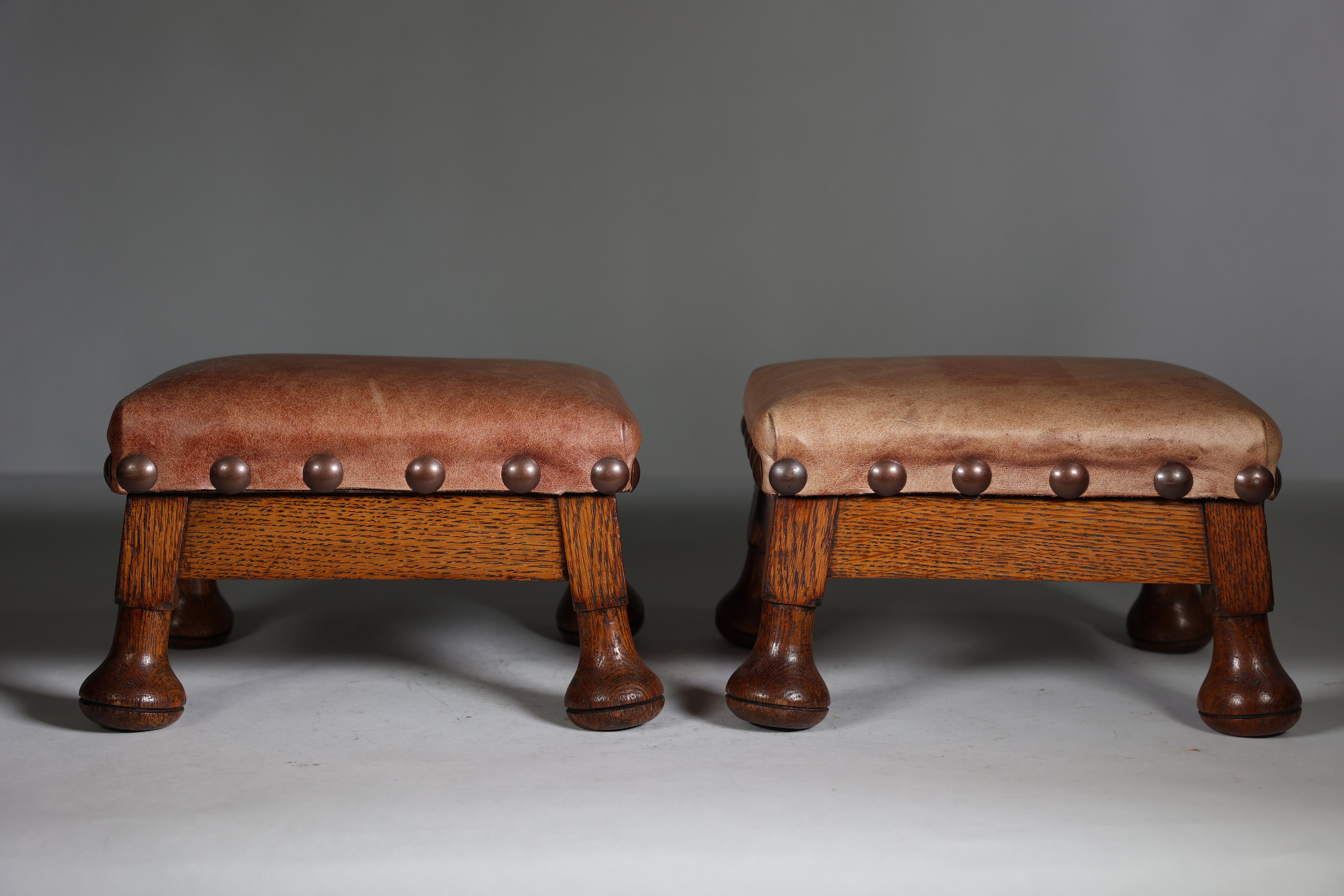 A little pair of Aesthetic Movement oak stools with leather studded seats, on Thebes style mushroom feet.